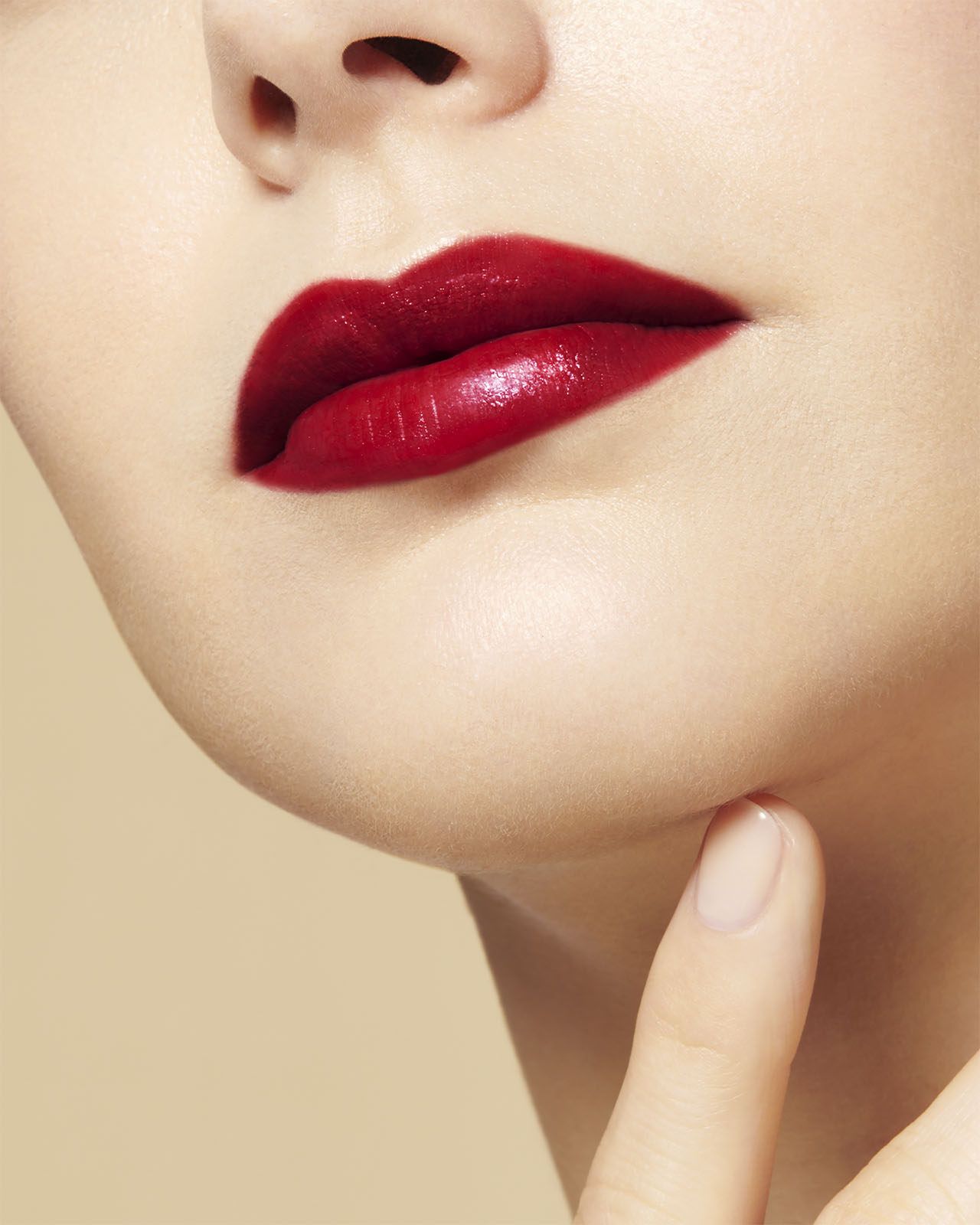 Photo of a light skin tone model  wearing "THE PRECIOUS LIPSTICK" on the lips, shown from a different angle.