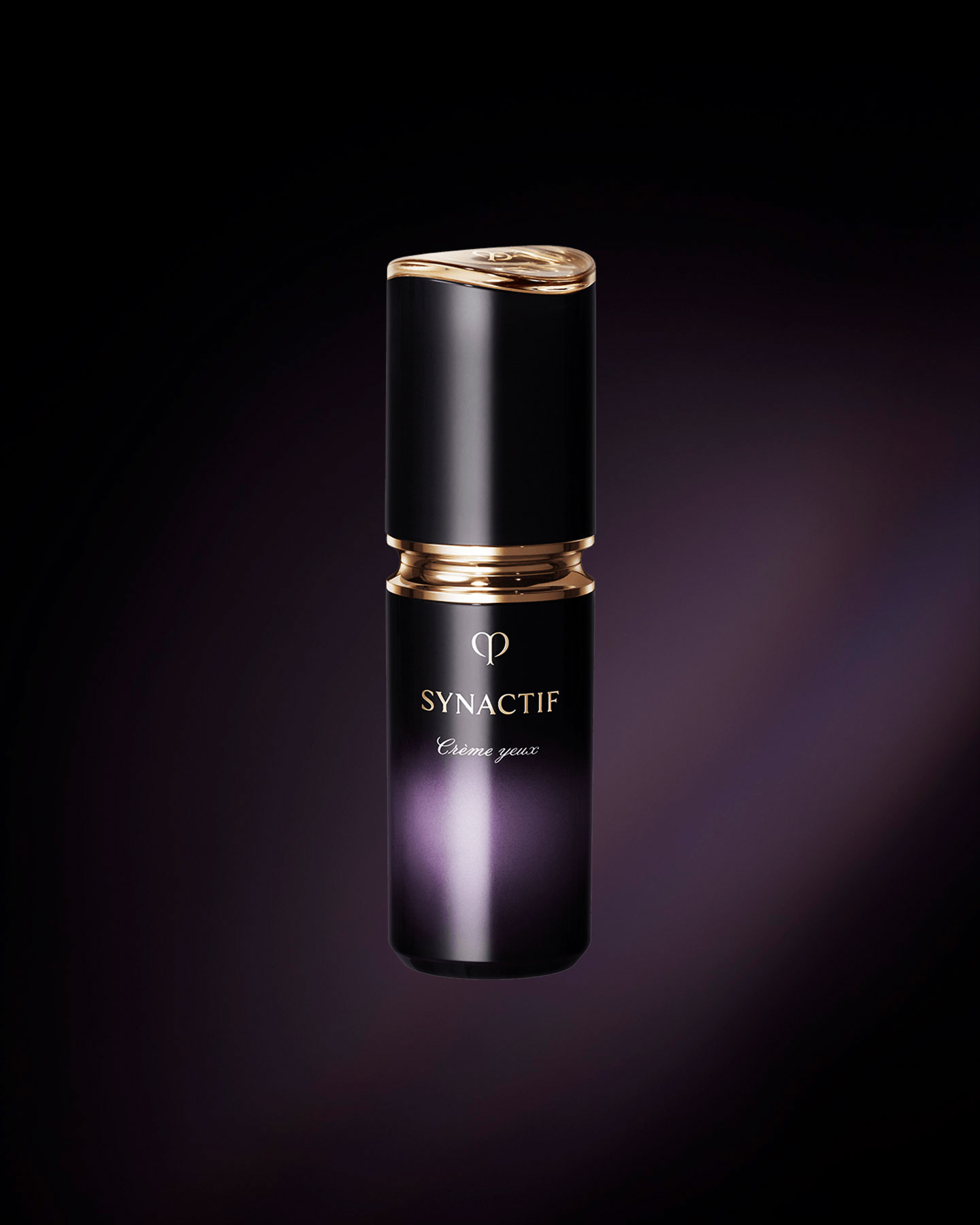 Photo of the Cl&eacute; de Peau Beaut&eacute; SYNACTIF EYE CREAM. It is housed in a compact cylindrical bottle featuring a black-to-purple gradient. A gold accent is placed between the cap and body, and the 'SYNACTIF' logo is displayed on the front.