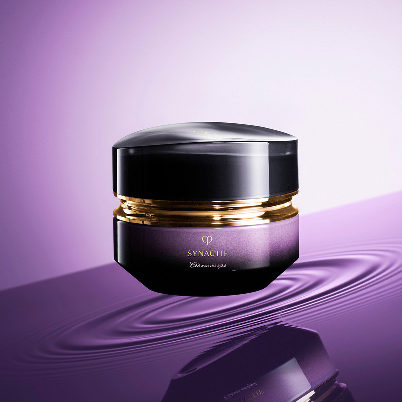 Photo of a jar of SYNACTIF body cream featuring a deep violet gradient glass body with a rounded, glossy black cap and gold accents.