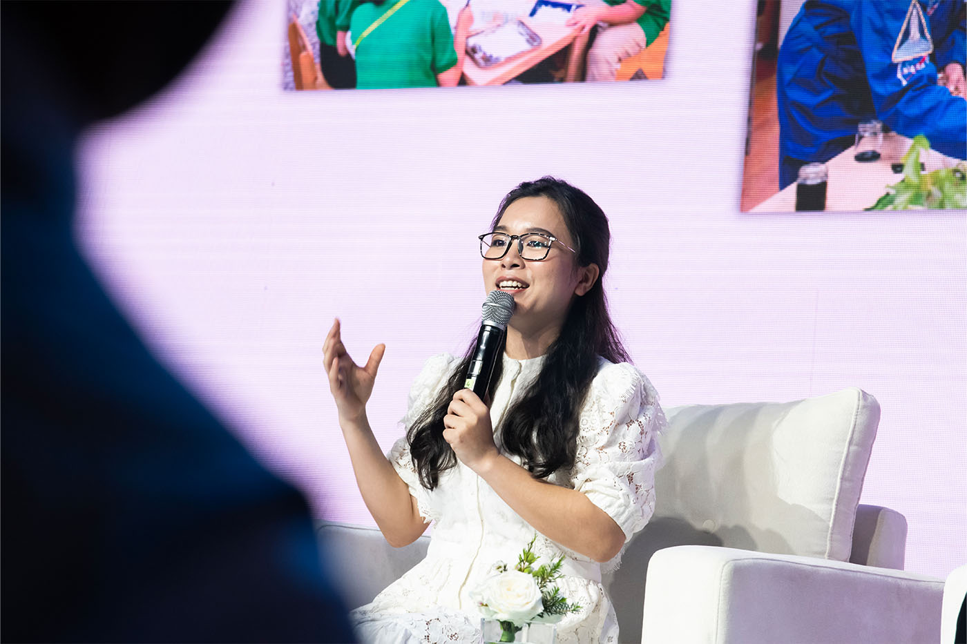 Photo of Ms. Dao Thi Hong Quyen speaking into a microphone during the 2023 Power of Radiance Awards ceremony.