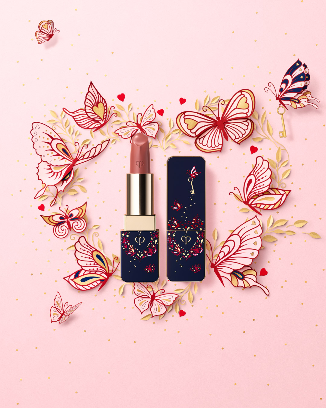  Photo of the limited-edition THE LIPSTICK 111 IN LIMITED-EDITION CASE. The blue-black case features a gold heart decorated with delicate pink butterfly motifs and a small gold key.