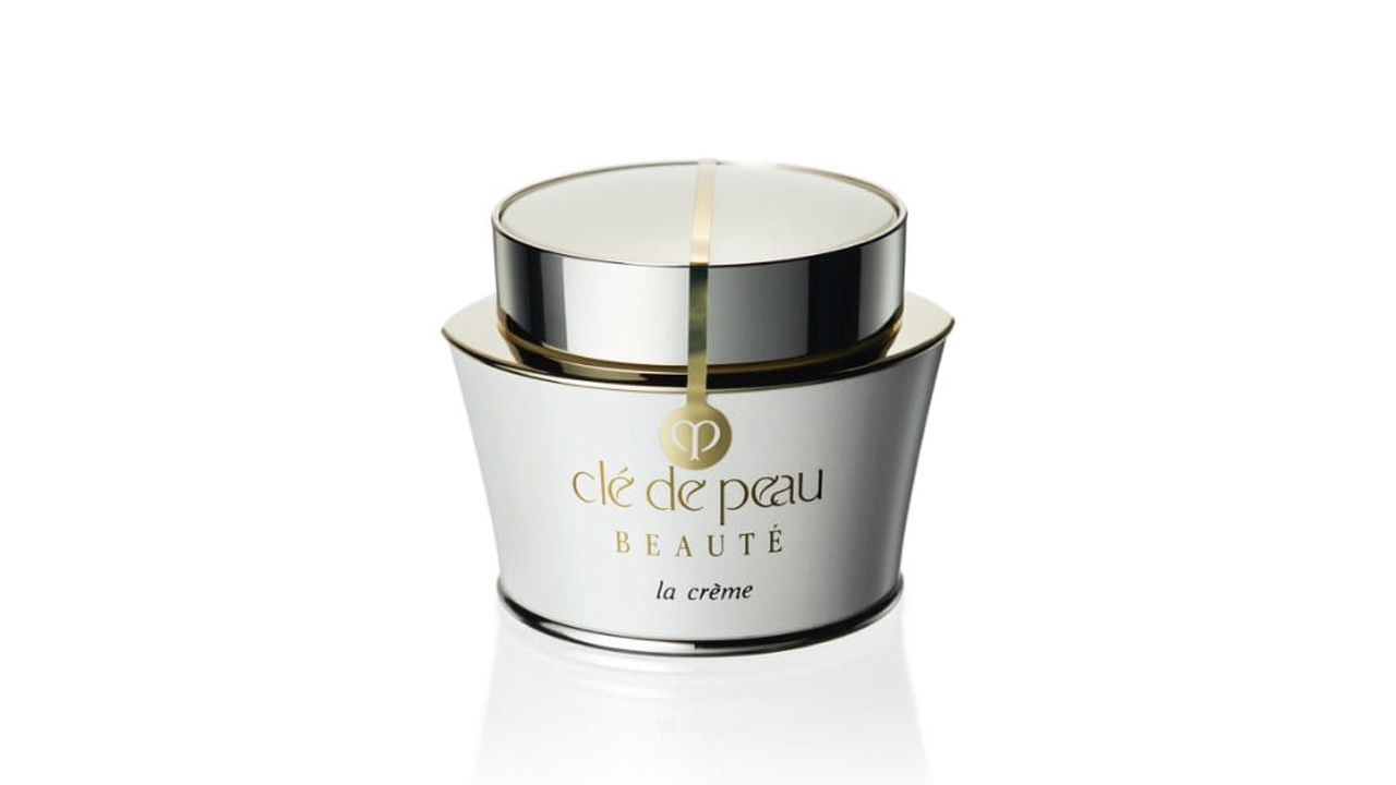 Photo of a soft white container accented with a silver cap and gold line. The front displays the brand logo and the text &ldquo;la cr&egrave;me&rdquo; (former packaging).