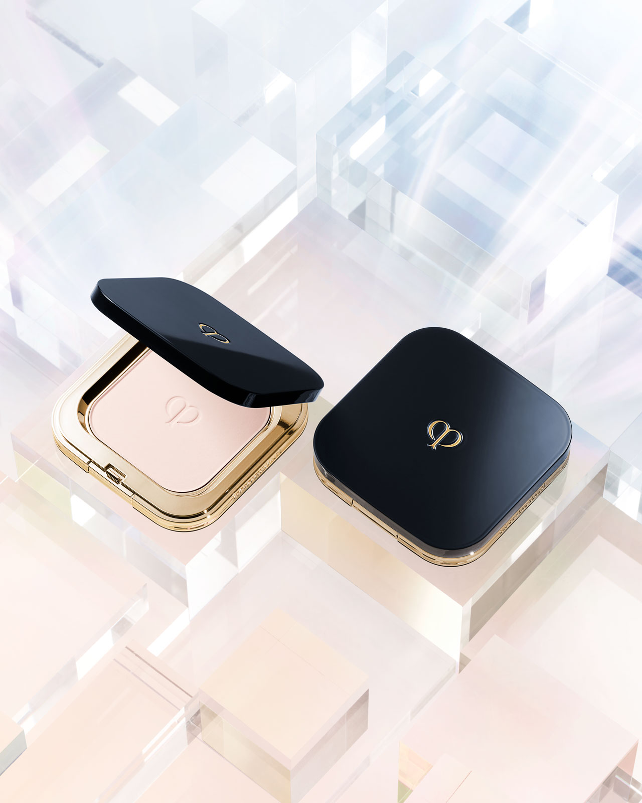 Photo of a blue-black REFINING PRESSED POWDER with a gold brand logo; the powder inside is also embossed with the same logo. 