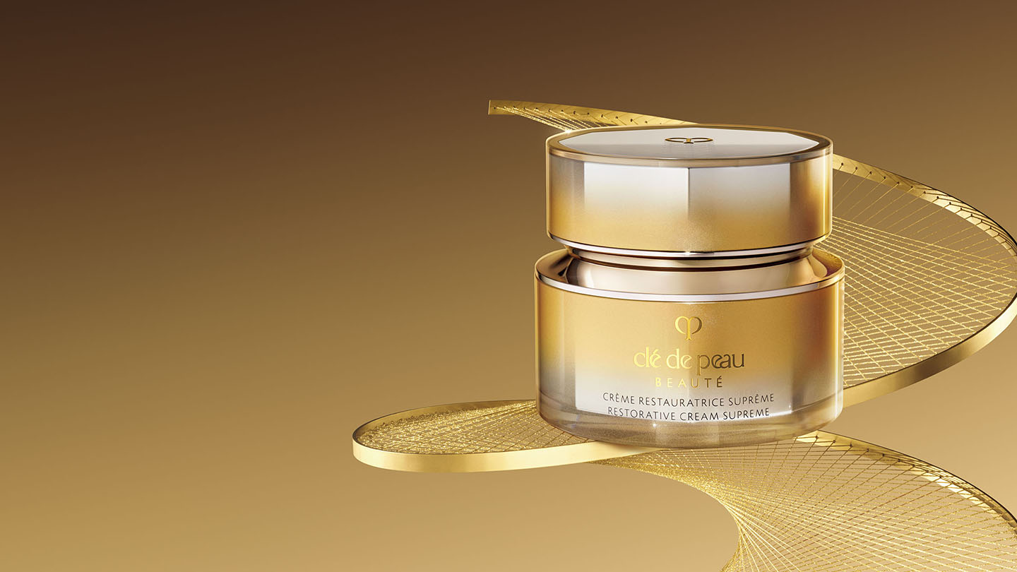 Photo of Brightening Serum Supreme bottle standing upright against a luminous background with golden rods and glowing spheres.
