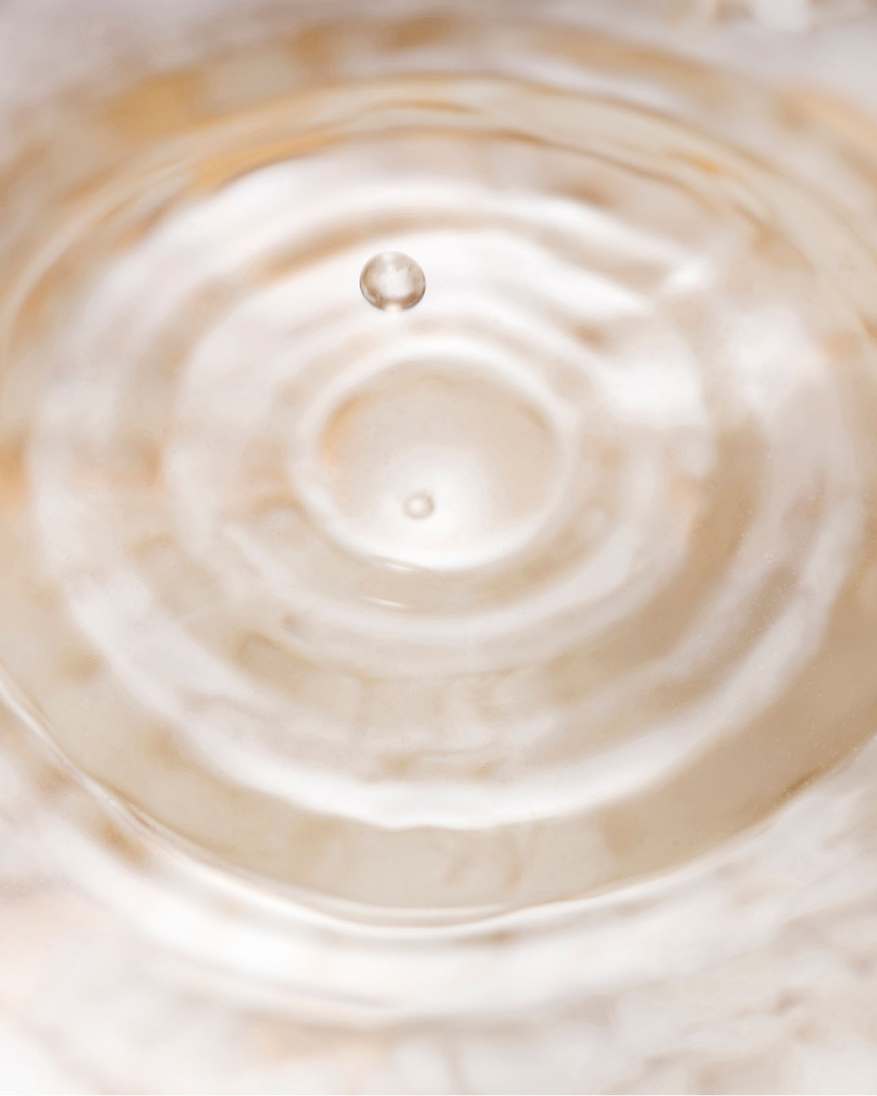 Photo of ripples spreading from the moment a single water droplet hits the surface.