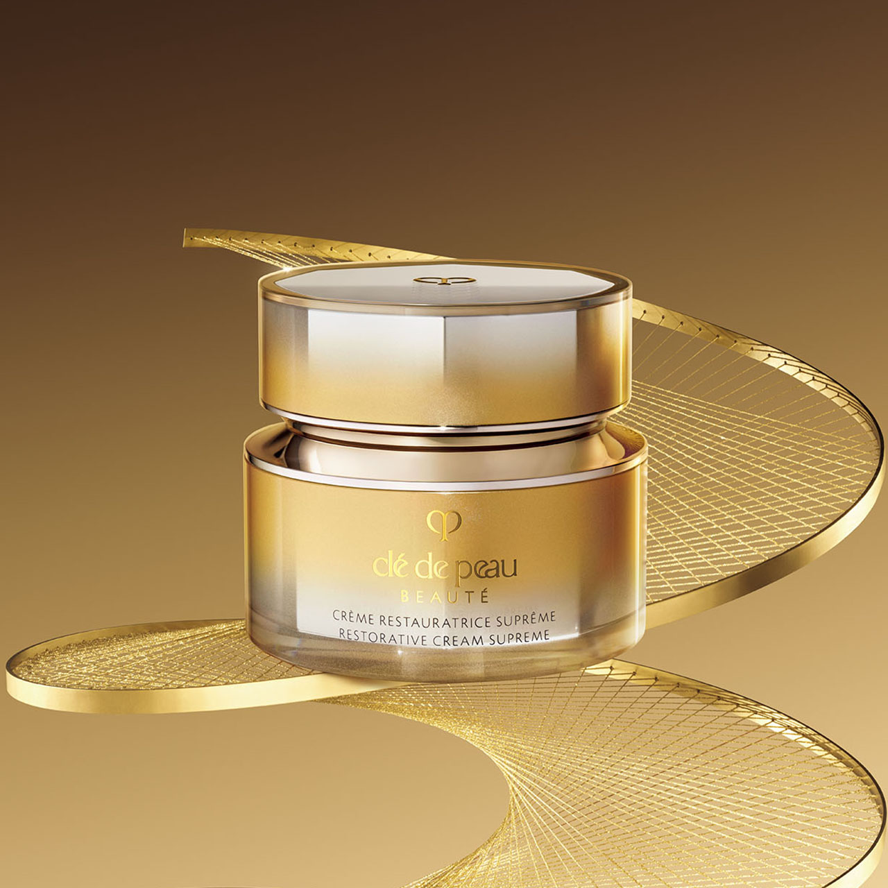 Photo of Brightening Serum Supreme bottle standing upright against a luminous background with golden rods and glowing spheres.