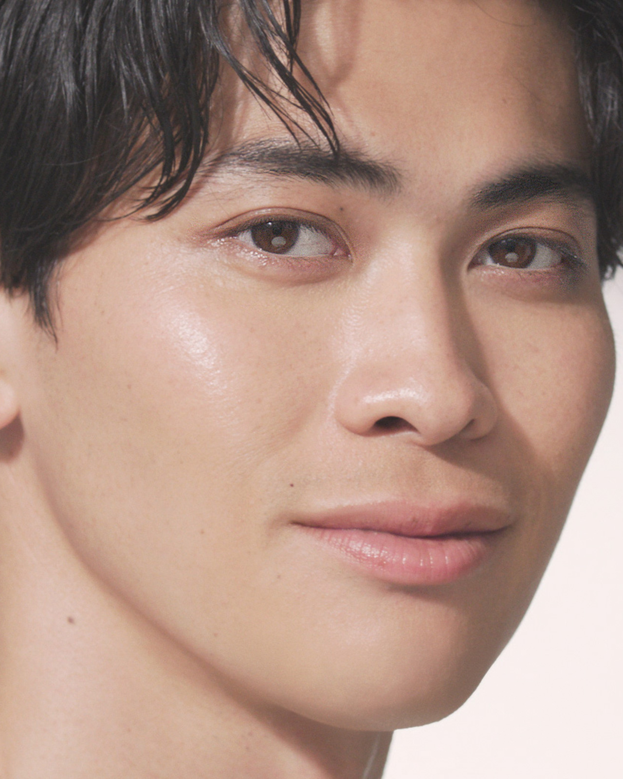 Photo of a man with a radiant, natural-looking complexion in a close-up.