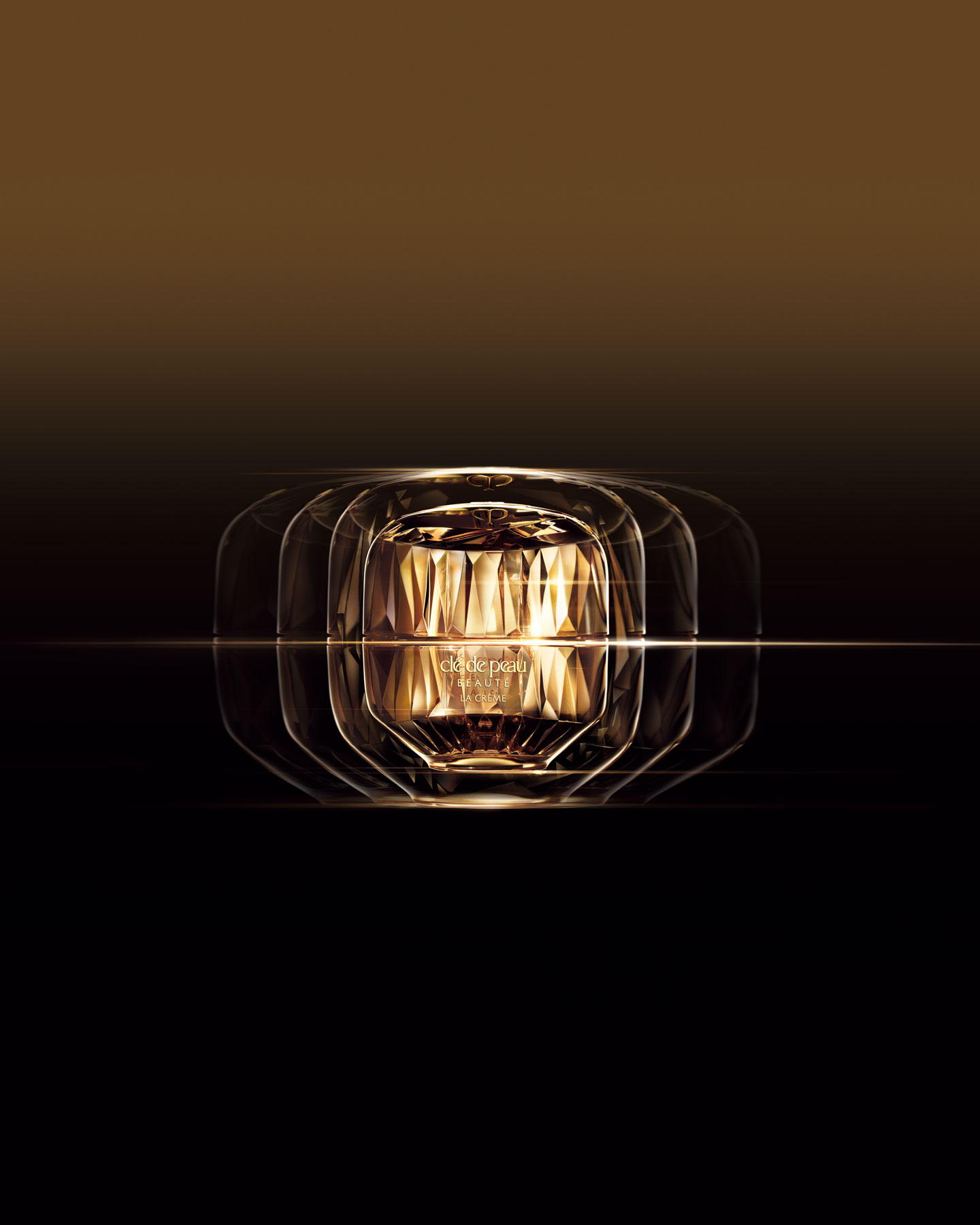 Photo of La Cr&egrave;me, captured in a cinematic music video style visual with layered reflections and golden light radiating from the faceted jar against a dark gradient background.