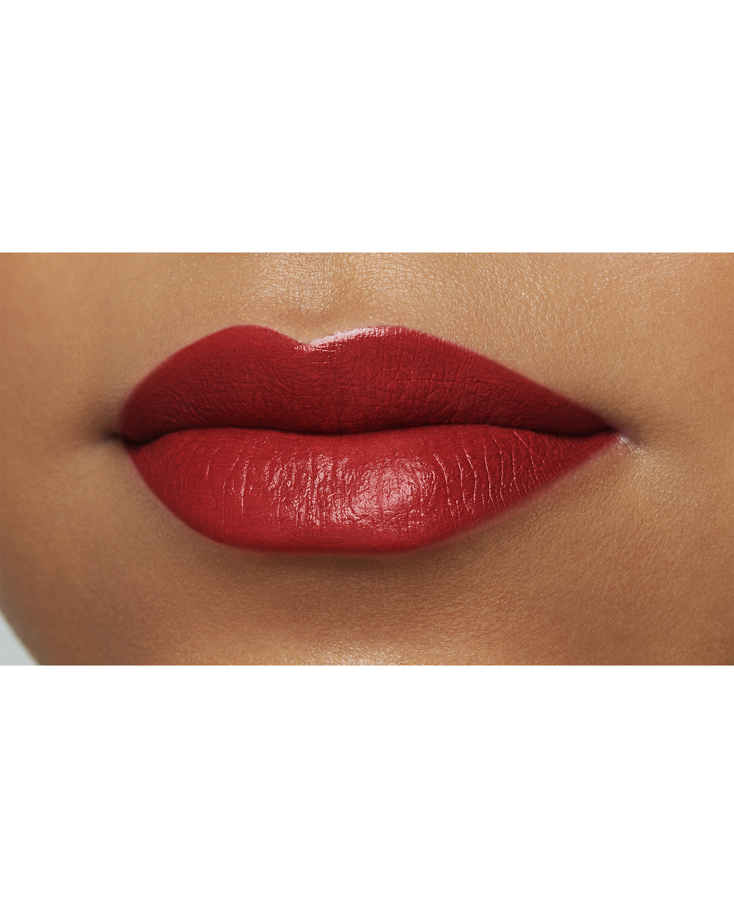 Photo of a deep skin tone model  wearing "LIPSTICK MATTE" in High Achieve on the lips.