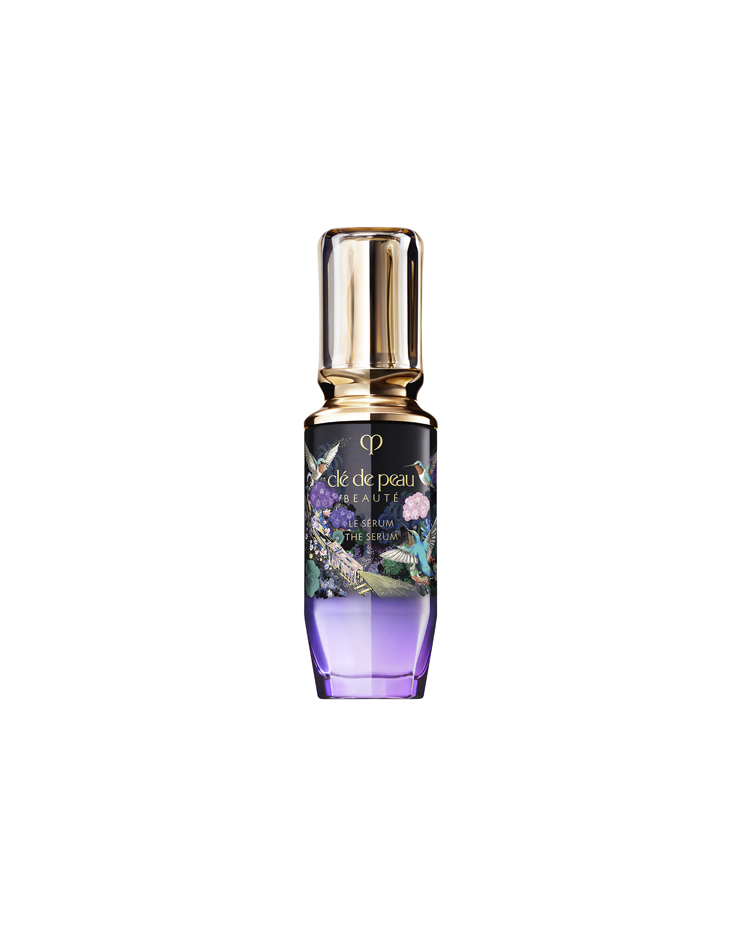 Photo of the limited-edition THE SERUM bottle. The design features a gold cap and a gradient bottle from deep violet to clear. The label showcases a gold train, blue birds, and colorful flowers. SIZE: 50ml