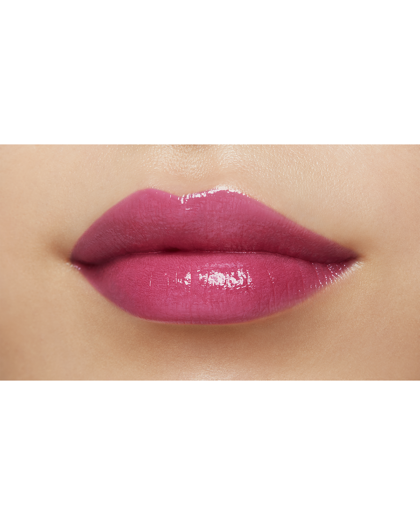 Photo of a medium skin tone model  wearing "LIPSTICK SHINE" in Go-Getter Grape on the lips.