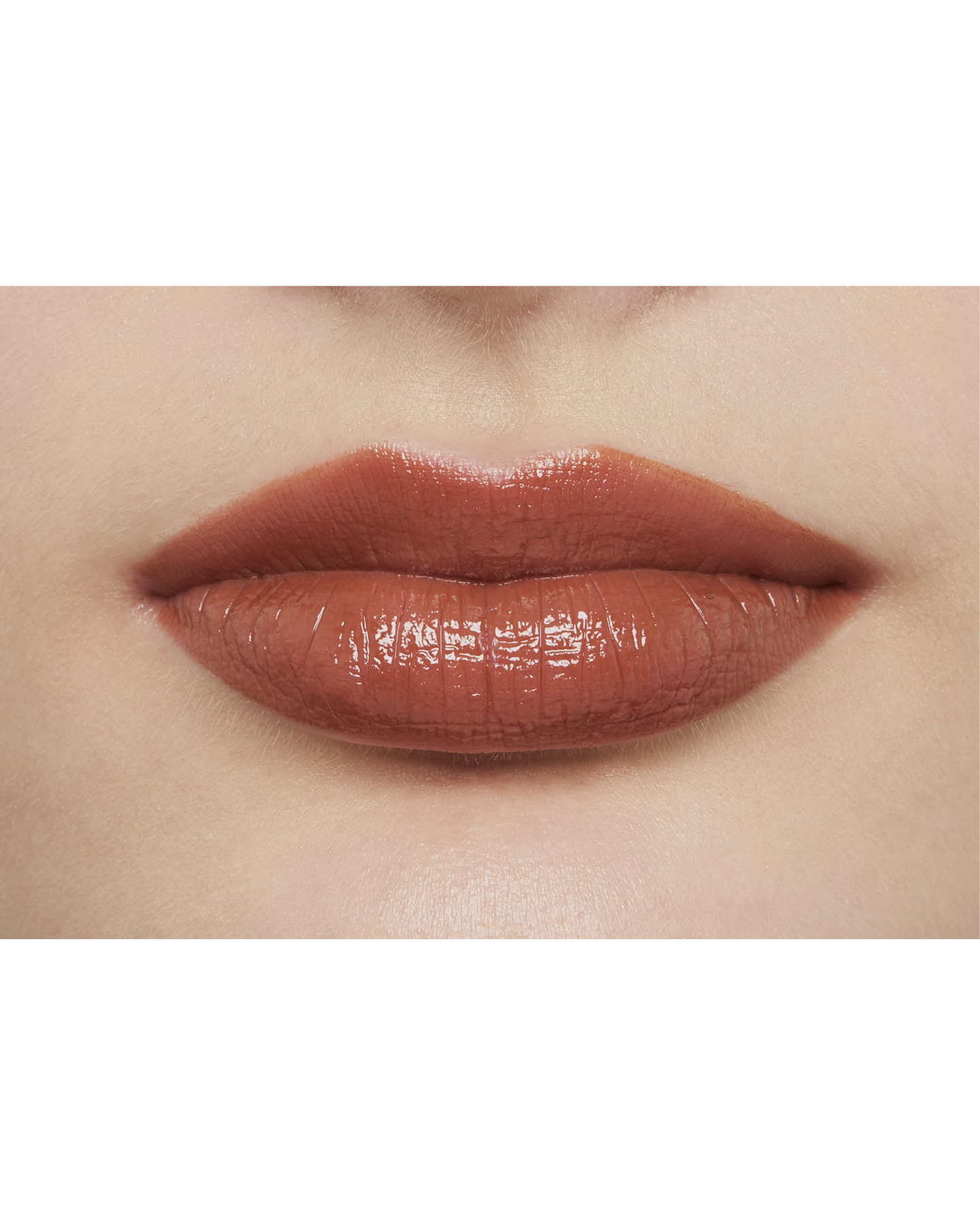 Photo of a light skin tone model  wearing  "LIPSTICK" in Amberkiss Pansy on the lips.