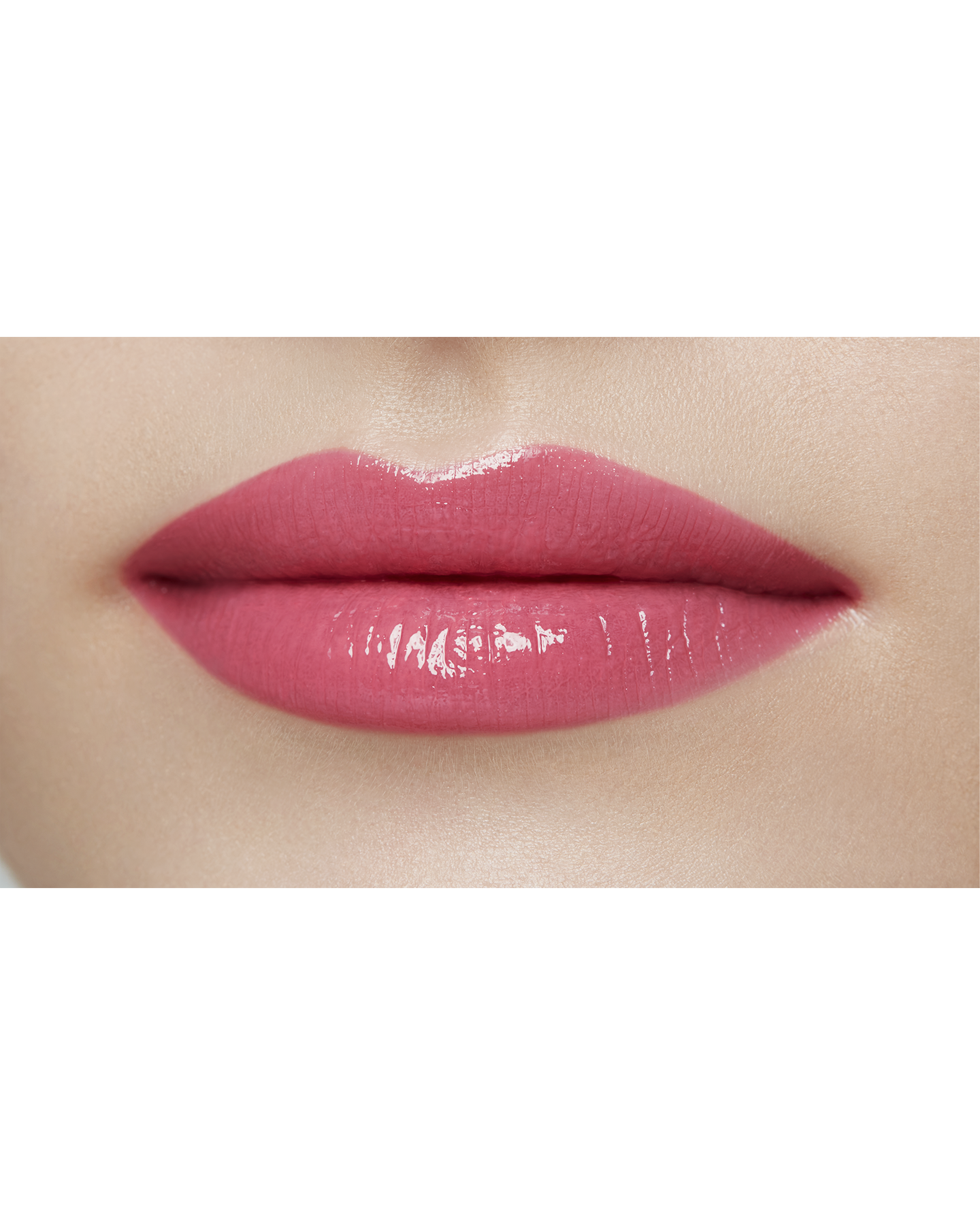 Photo of a light skin tone model  wearing  "LIPSTICK SHINE" in Impulsive on the lips.