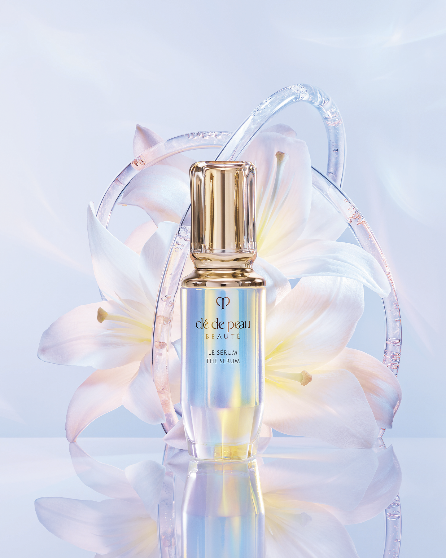 Photo of THE SERUM bottle displayed in front of a large white lily.