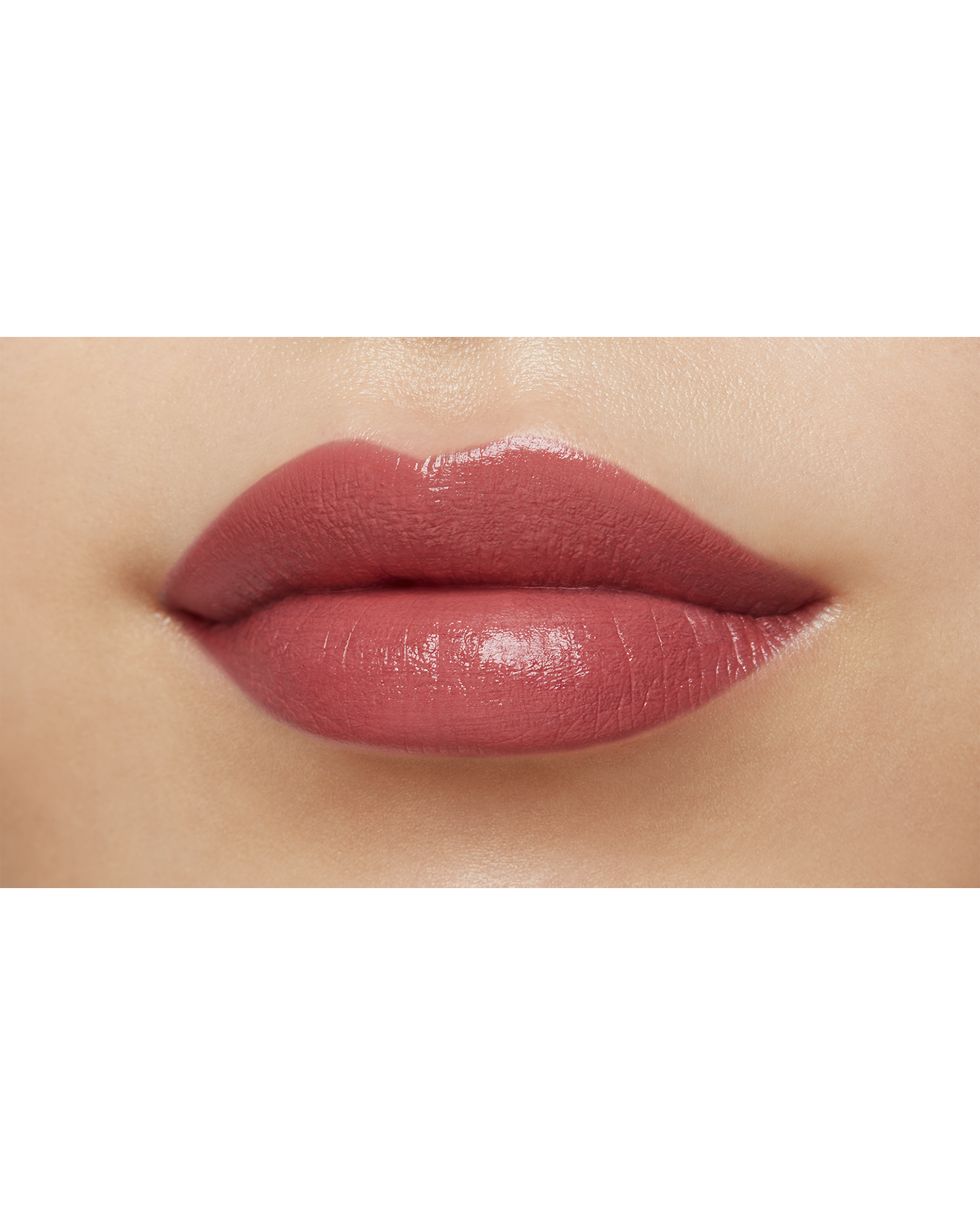 Photo of a medium skin tone model  wearing "LIPSTICK MATTE" in High Achieve on the lips.