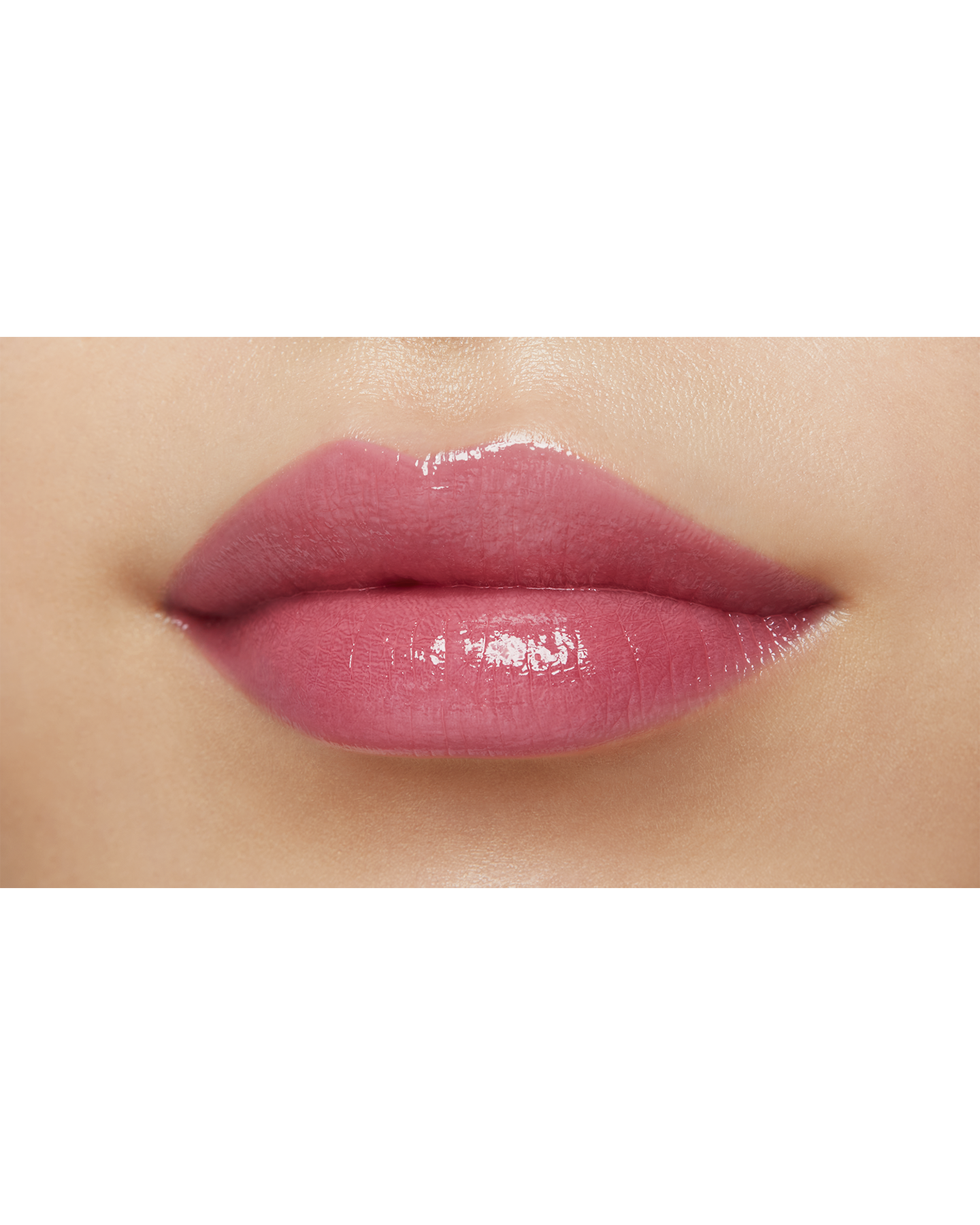 Photo of a medium skin tone model  wearing "LIPSTICK SHINE" in Playful Pink on the lips.