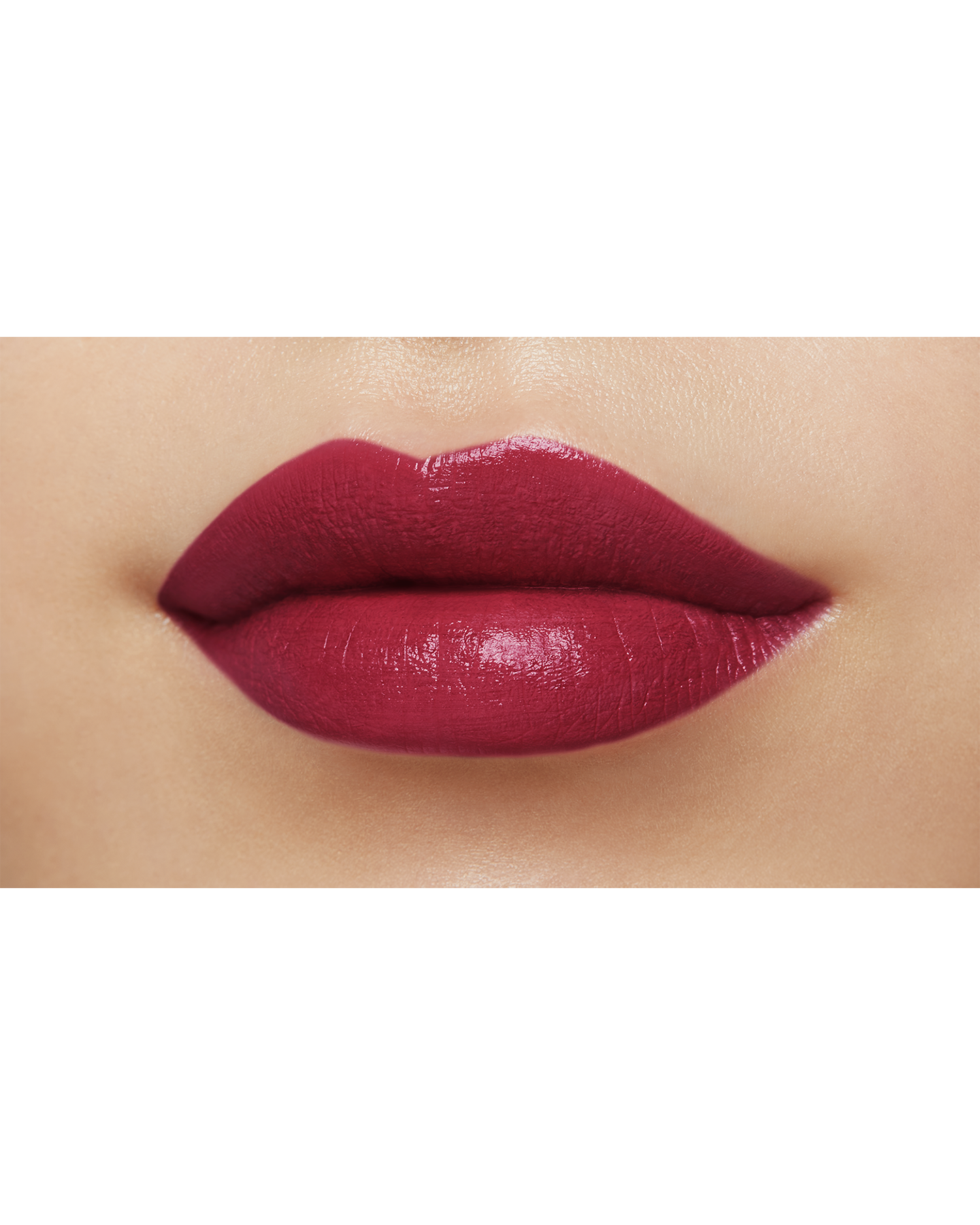 Photo of a medium skin tone model  wearing "LIPSTICK MATTE" in High Achieve on the lips.