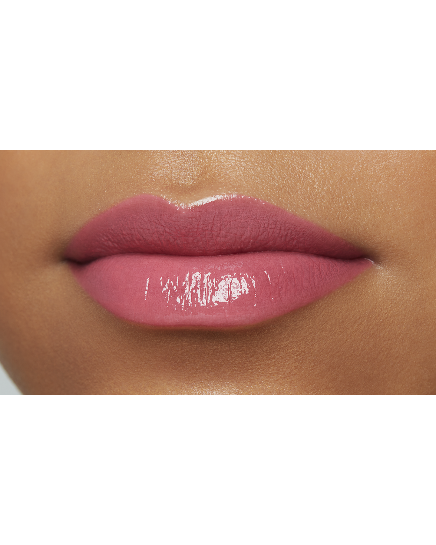 Photo of a deep skin tone model  wearing  "LIPSTICK SHINE" in Playful Pink on the lips.