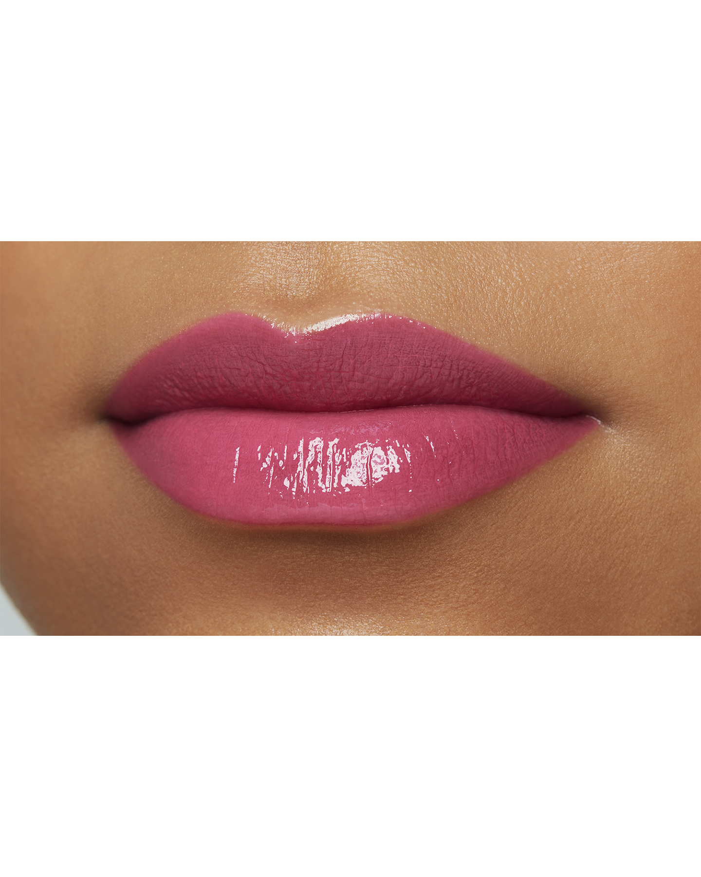 Photo of a deep skin tone model  wearing  "LIPSTICK SHINE" in Go-Getter Grape on the lips.
