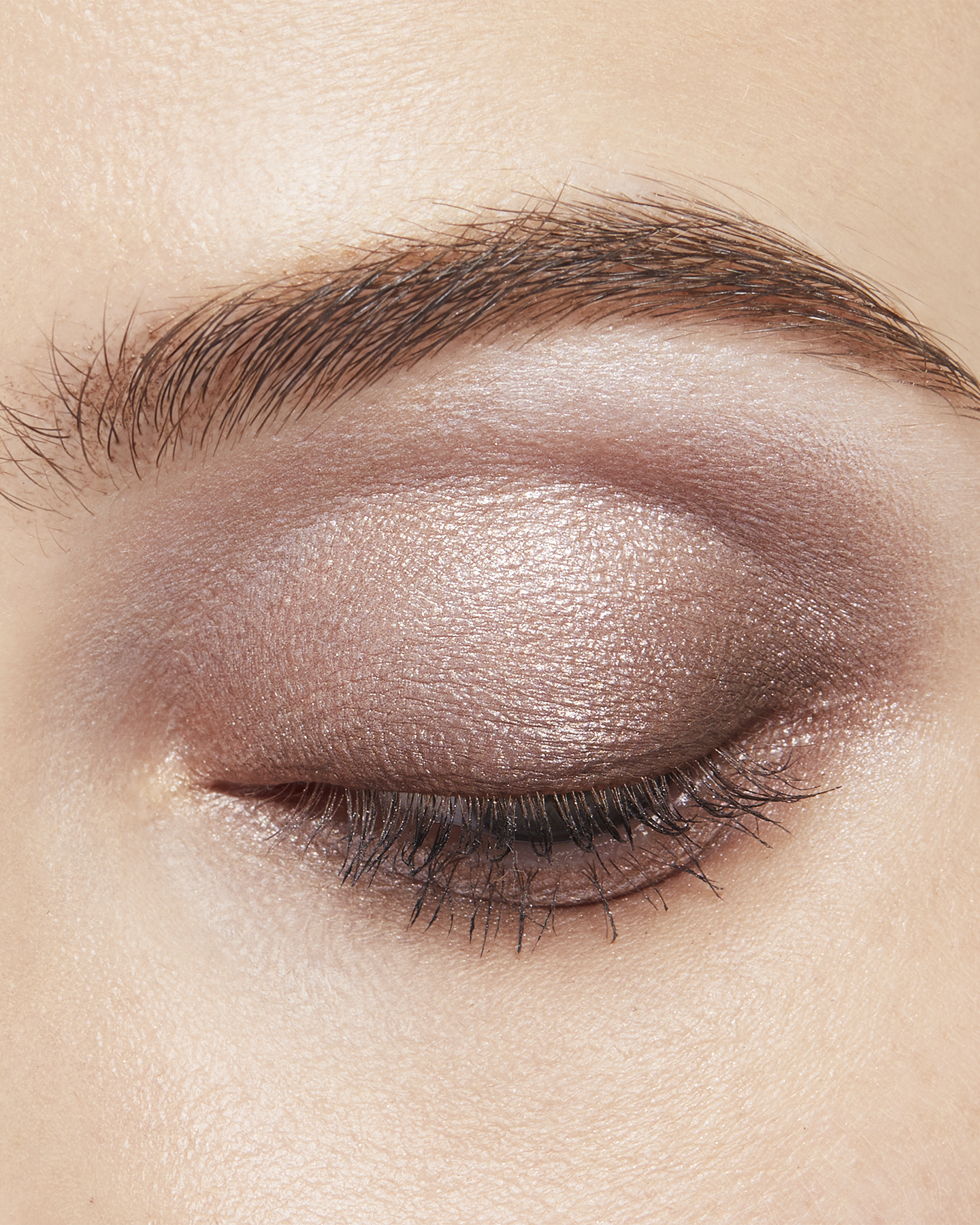 Photo of a light skin tone model wearing EYE COLOR QUAD in 1-Sand Dunet on the eyes.