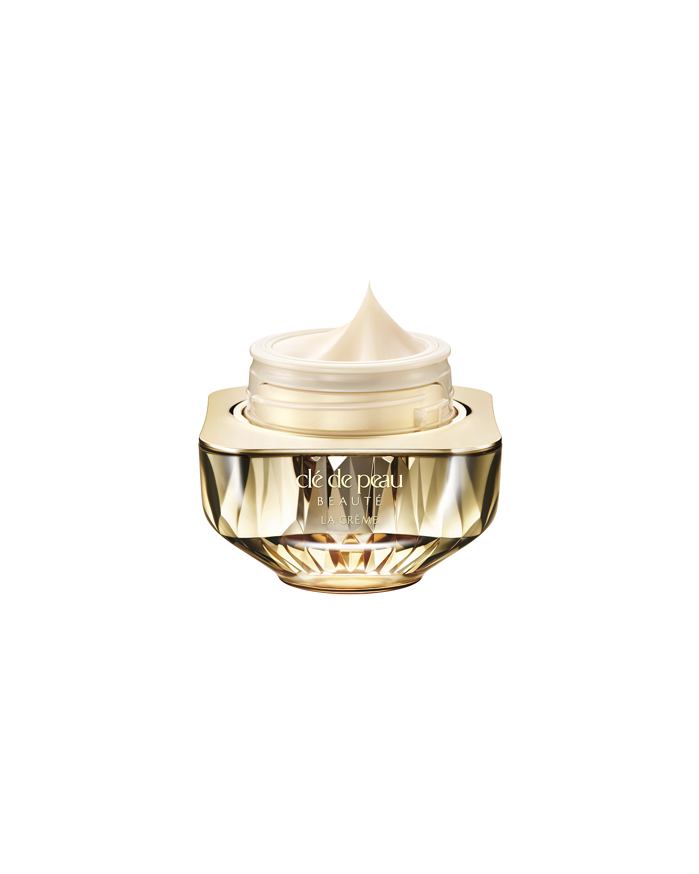 Photo of Cl&eacute; de Peau Beaut&eacute;&rsquo;s high-performance cream &ldquo;La Cr&egrave;me,&rdquo; housed in a jewel-cut, translucent gold container. The lid is open, revealing the smooth cream inside.
