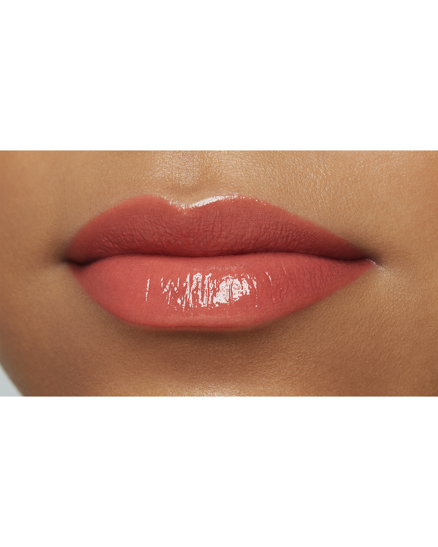 Photo of a deep skin tone model  wearing  "LIPSTICK SHINE" in Red-Orange Rebel on the lips.