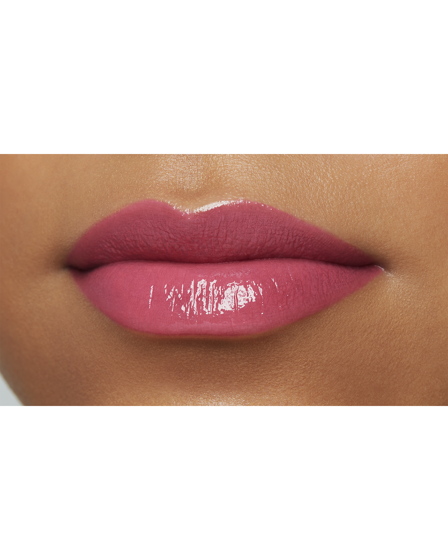 Photo of a deep skin tone model  wearing  "LIPSTICK SHINE" in Impulsive on the lips.