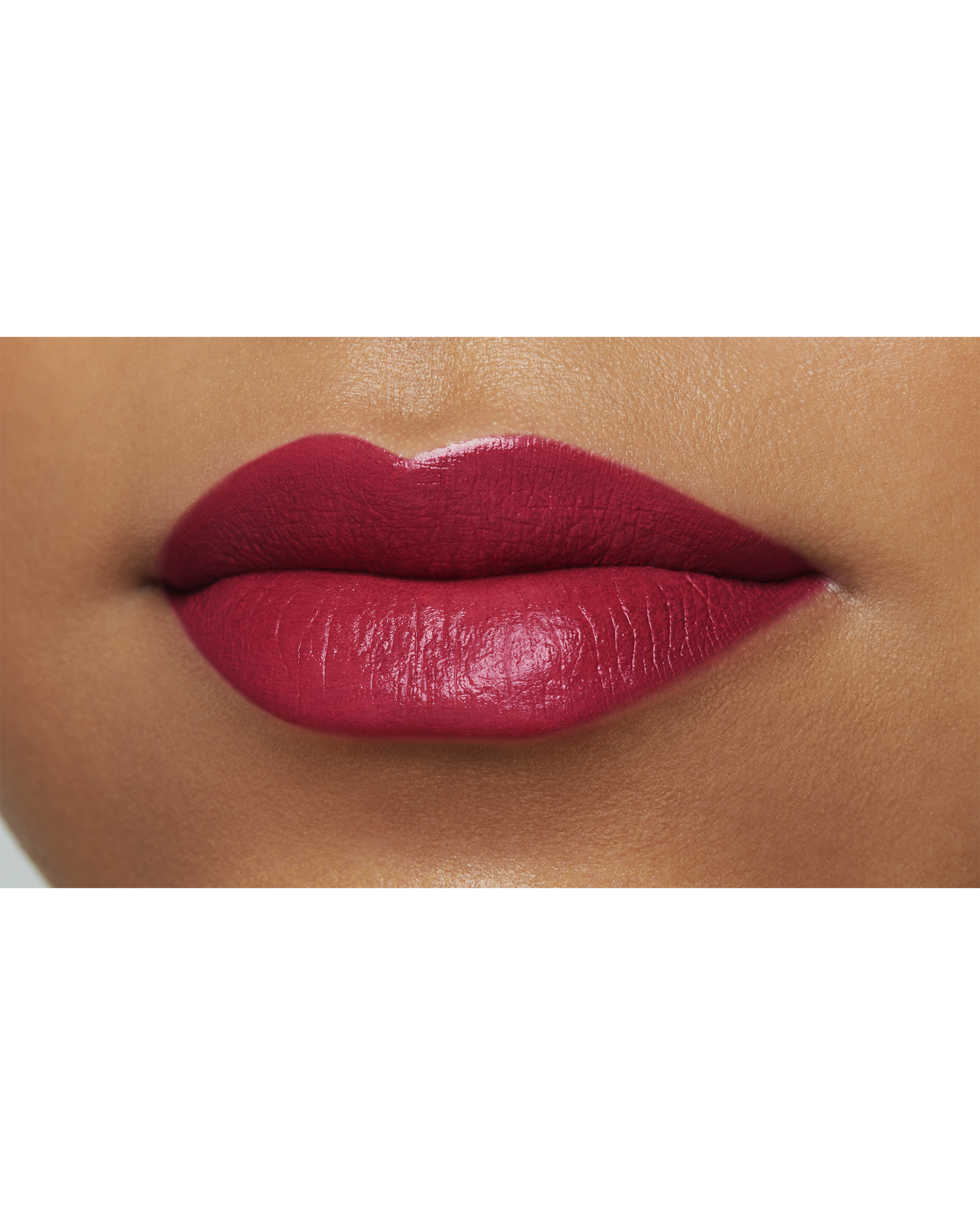 Photo of a deep skin tone model  wearing "LIPSTICK MATTE" in High Achieve on the lips.