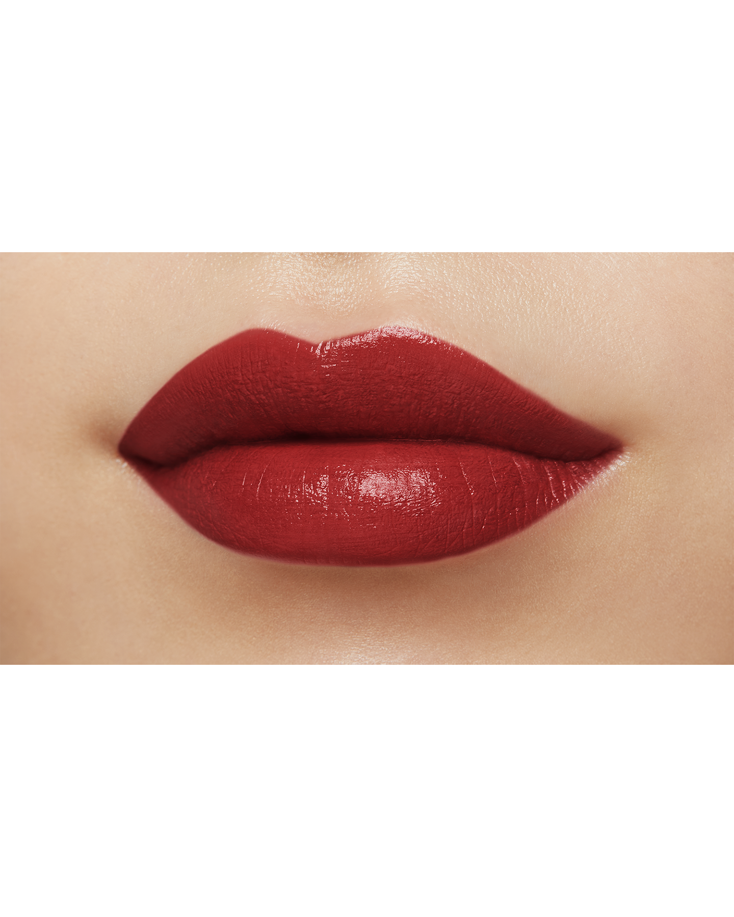 Photo of a medium skin tone model  wearing "LIPSTICK MATTE" in High Achieve on the lips.