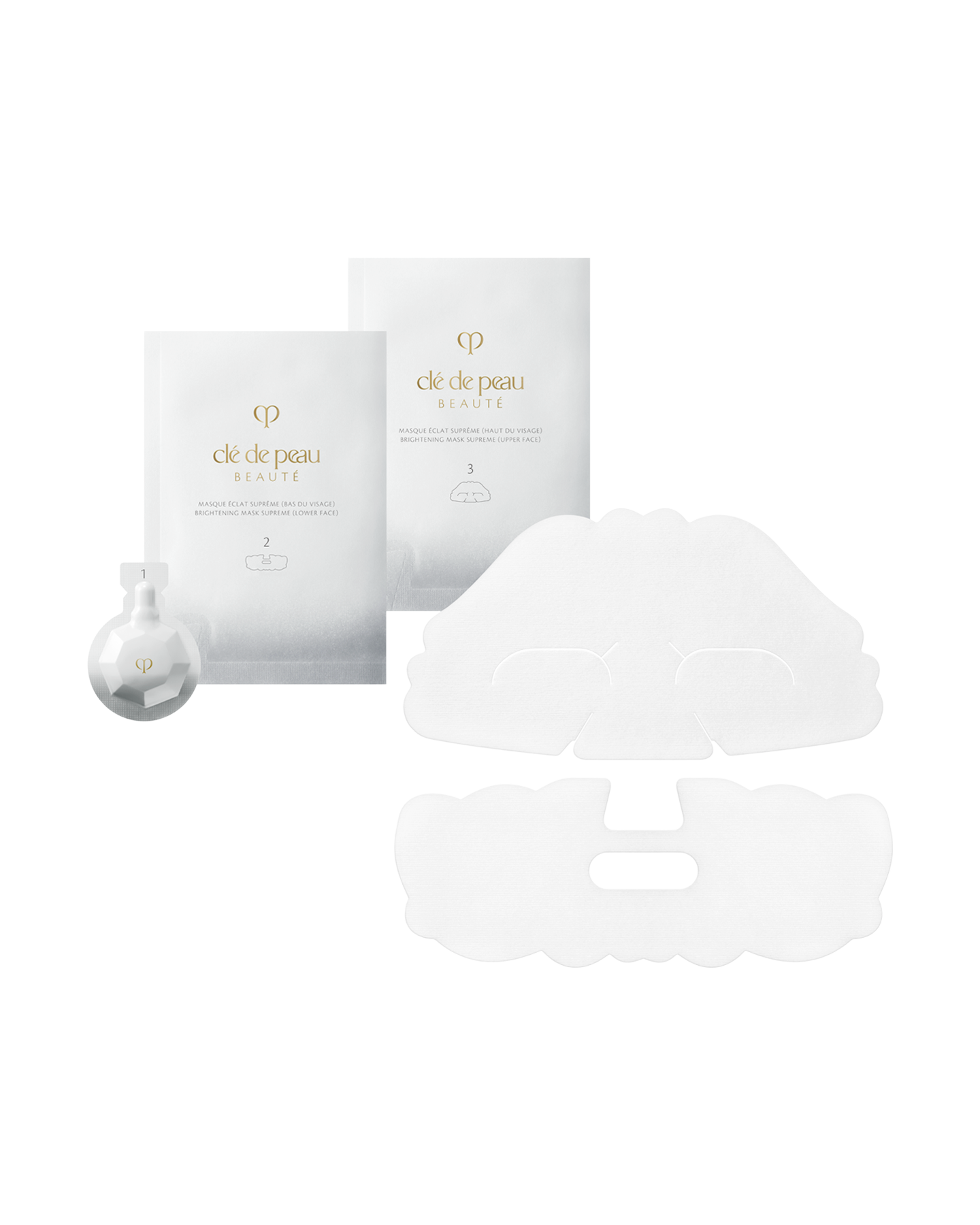 Photo of BRIGHTENING MASK TREATMENT SUPREME, showing two silver sheet mask packets for upper and lower face, a small faceted white exfoliating gel package on the left, and two unfolded white sheet masks.