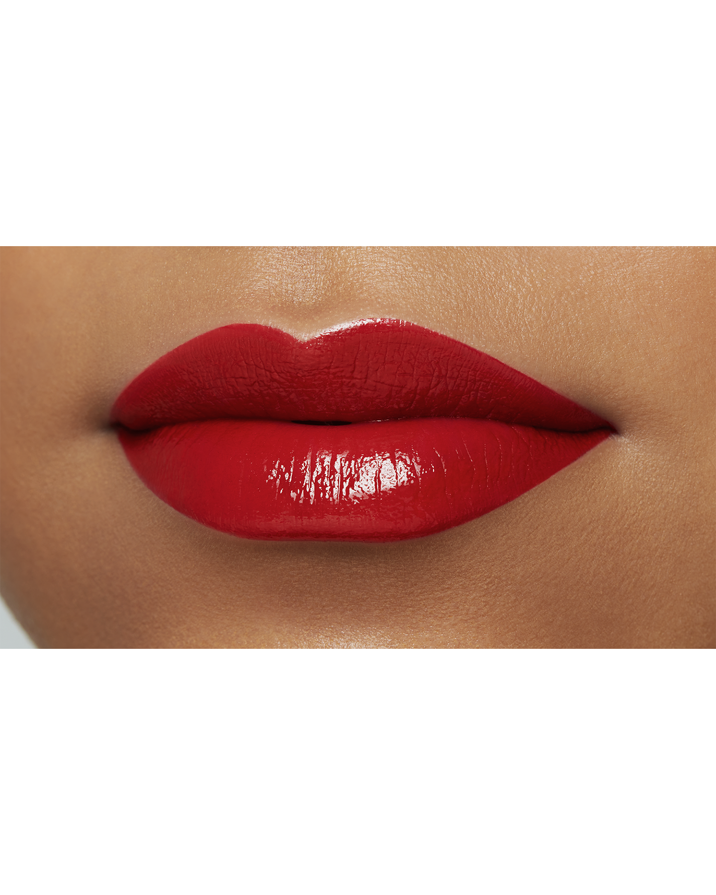 Photo of the lips of a model with a deep skin tone wearing "LIPSTICK" in the shade Legend of Rouge.