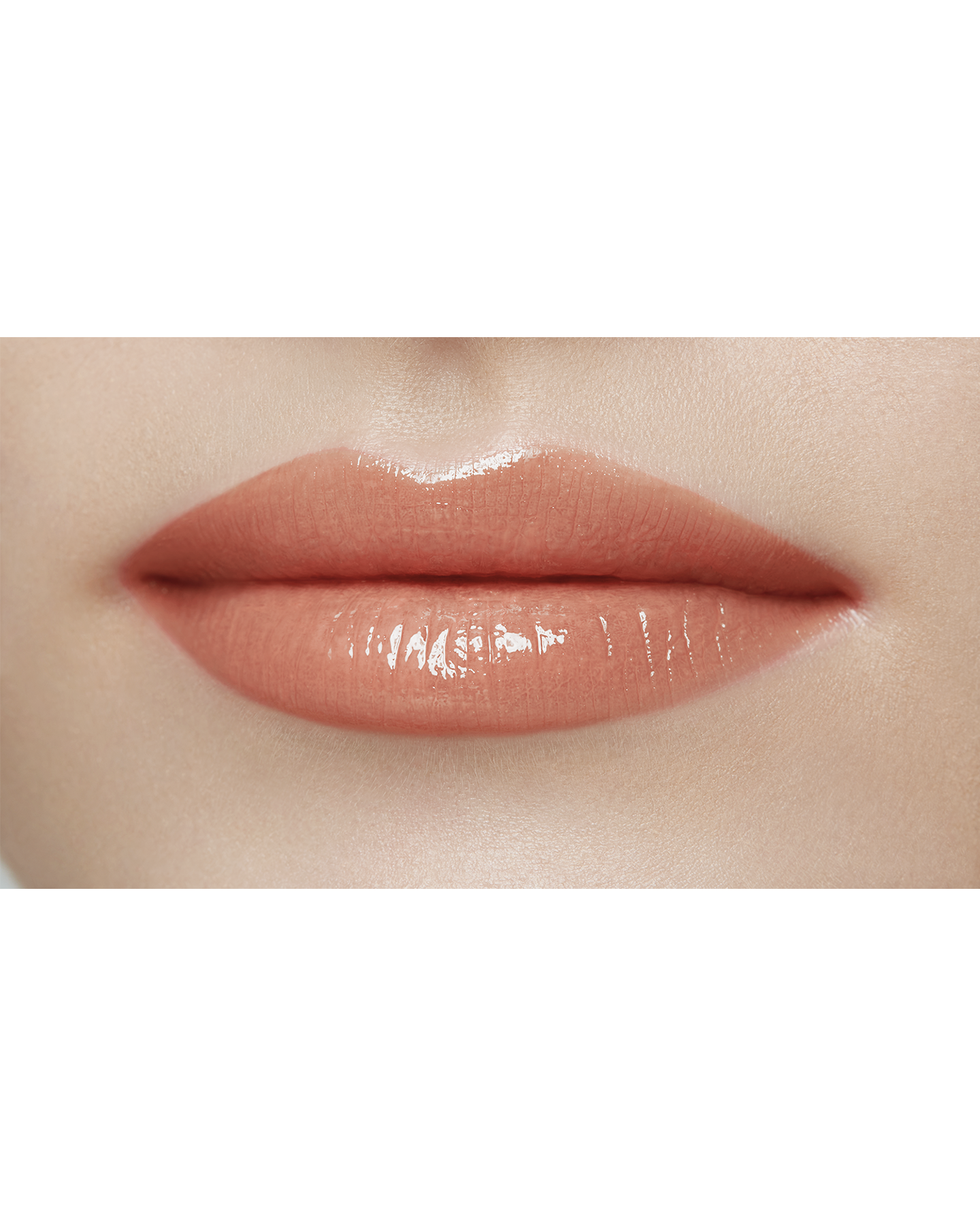 Photo of a light skin tone model  wearing  "LIPSTICK SHINE" in Transcendent on the lips.