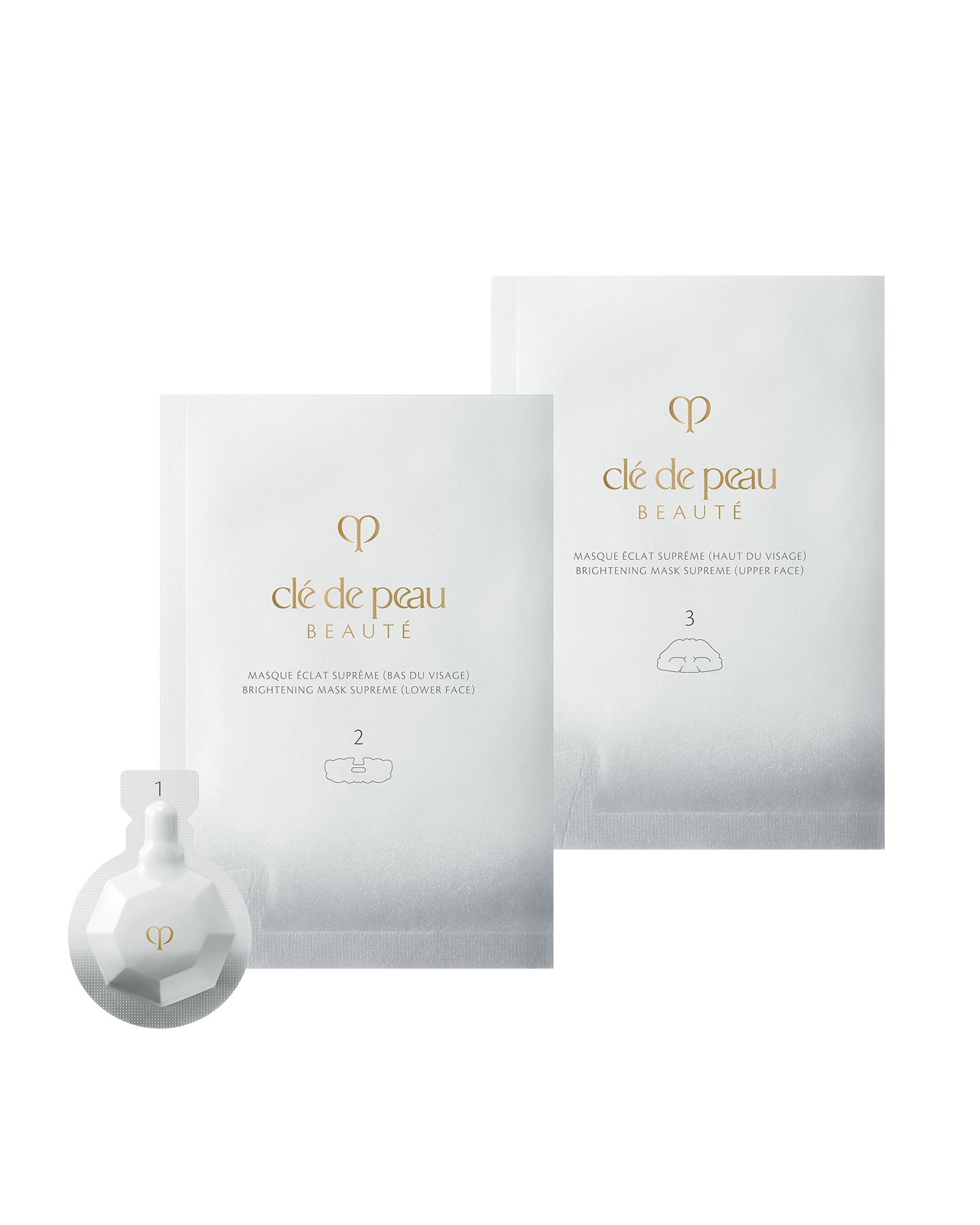 Photo of BRIGHTENING MASK TREATMENT SUPREME. From left to right: a faceted white exfoliating gel package (step 1), a silver sheet mask packet for the lower face (step 2), and a silver sheet mask packet for the upper face (step 3).