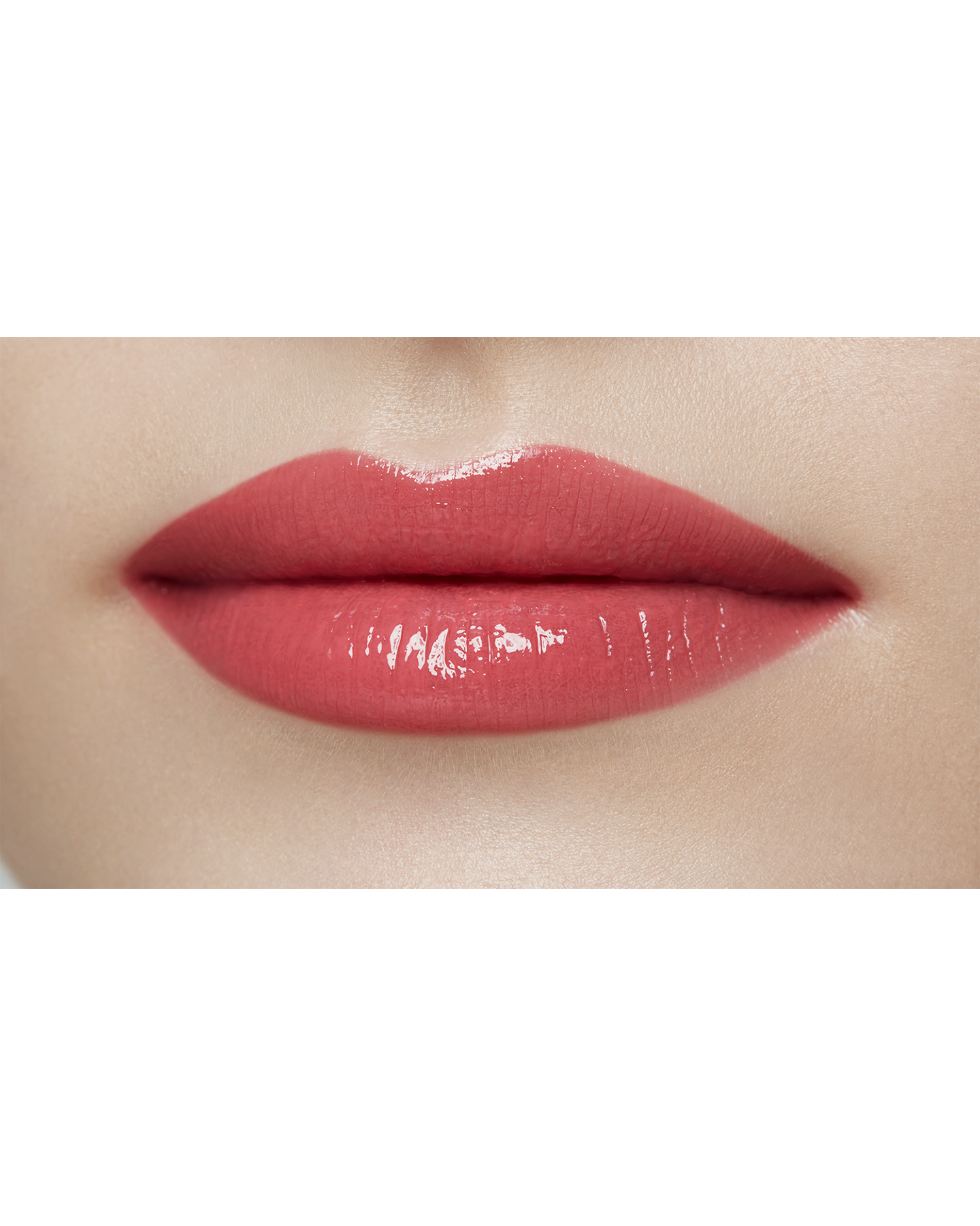 Photo of a light skin tone model  wearing  "LIPSTICK SHINE" in Always-Right Red on the lips.