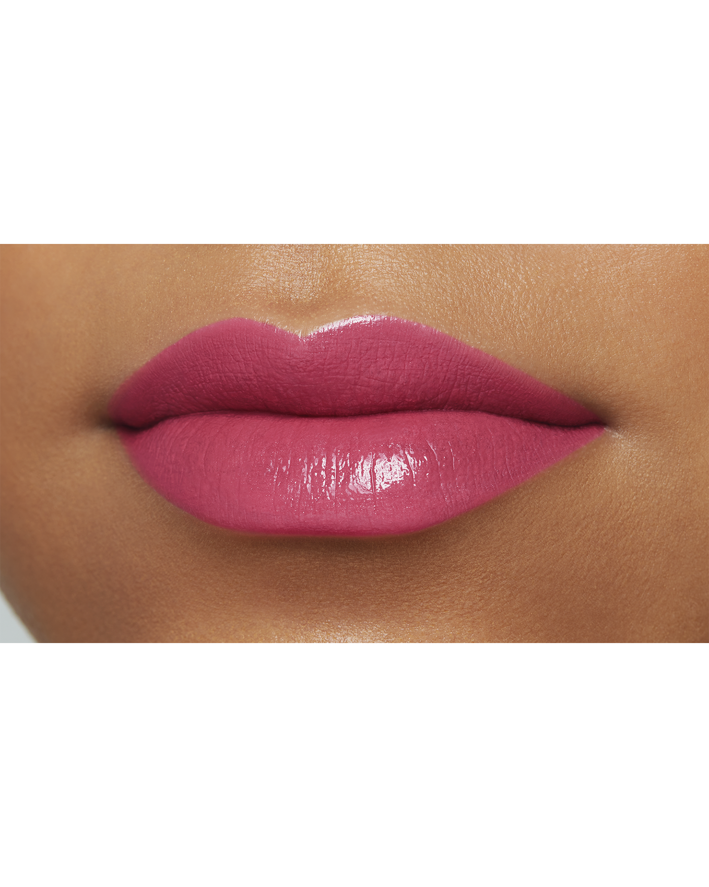 Photo of the lips of a model with a deep skin tone wearing "LIPSTICK" in the shade A Flair for Fuchsia.