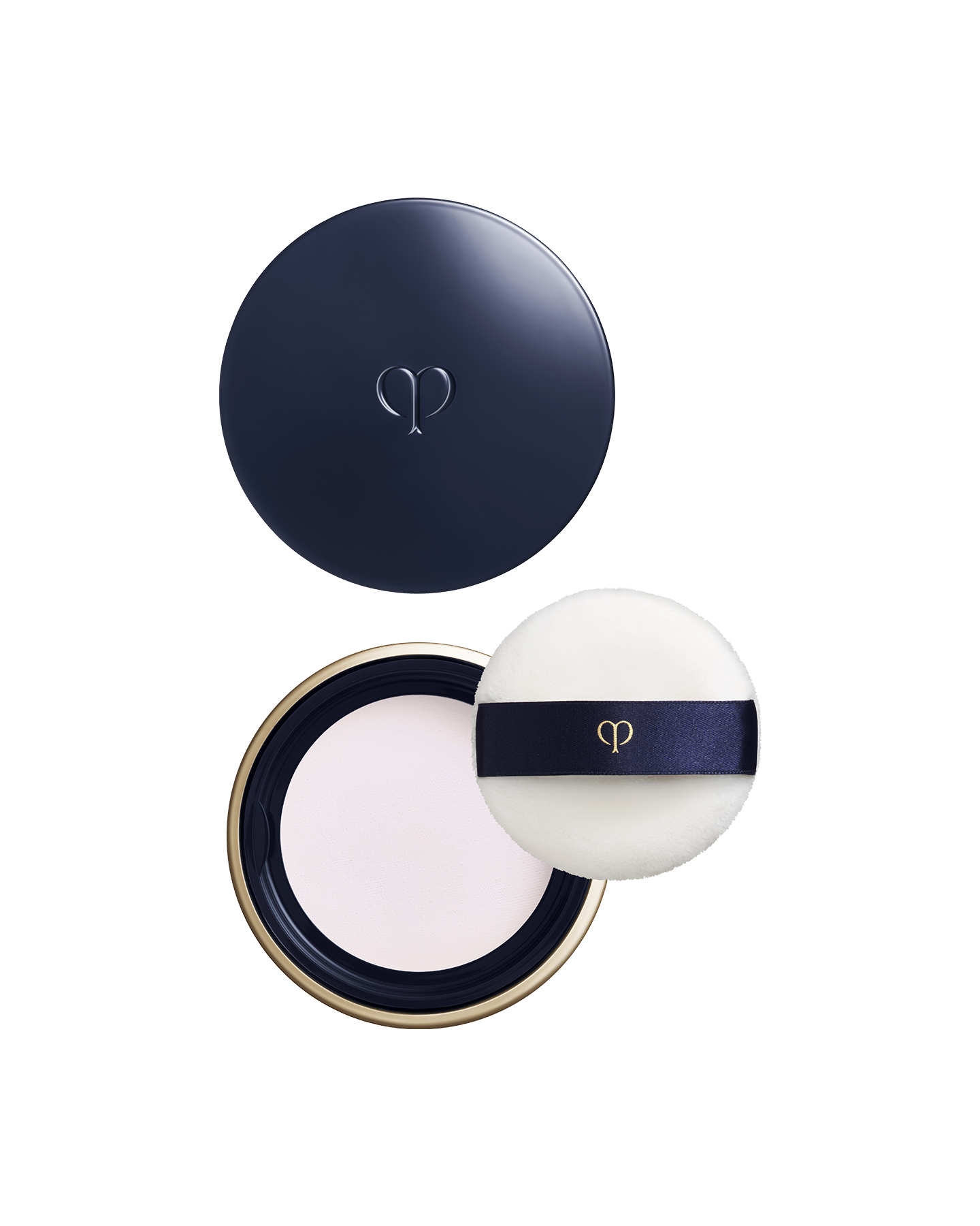 Photo of a round, blue-black and gold container with the lid placed above, showing the powder inside the main body below. On the right side, there is a white puff with a ribbon band and brand logo. Shade: Light.
