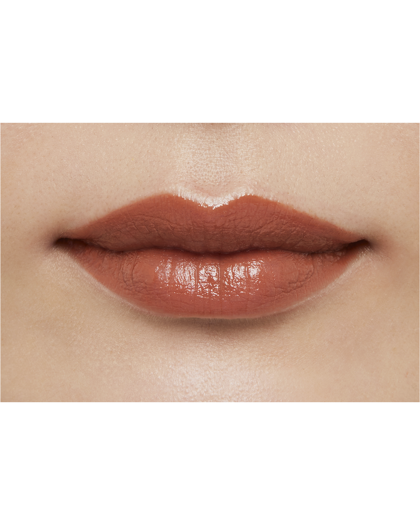 Photo of a medium skin tone model  wearing "LIPSTICK" in Amberkiss Pansy on the lips.