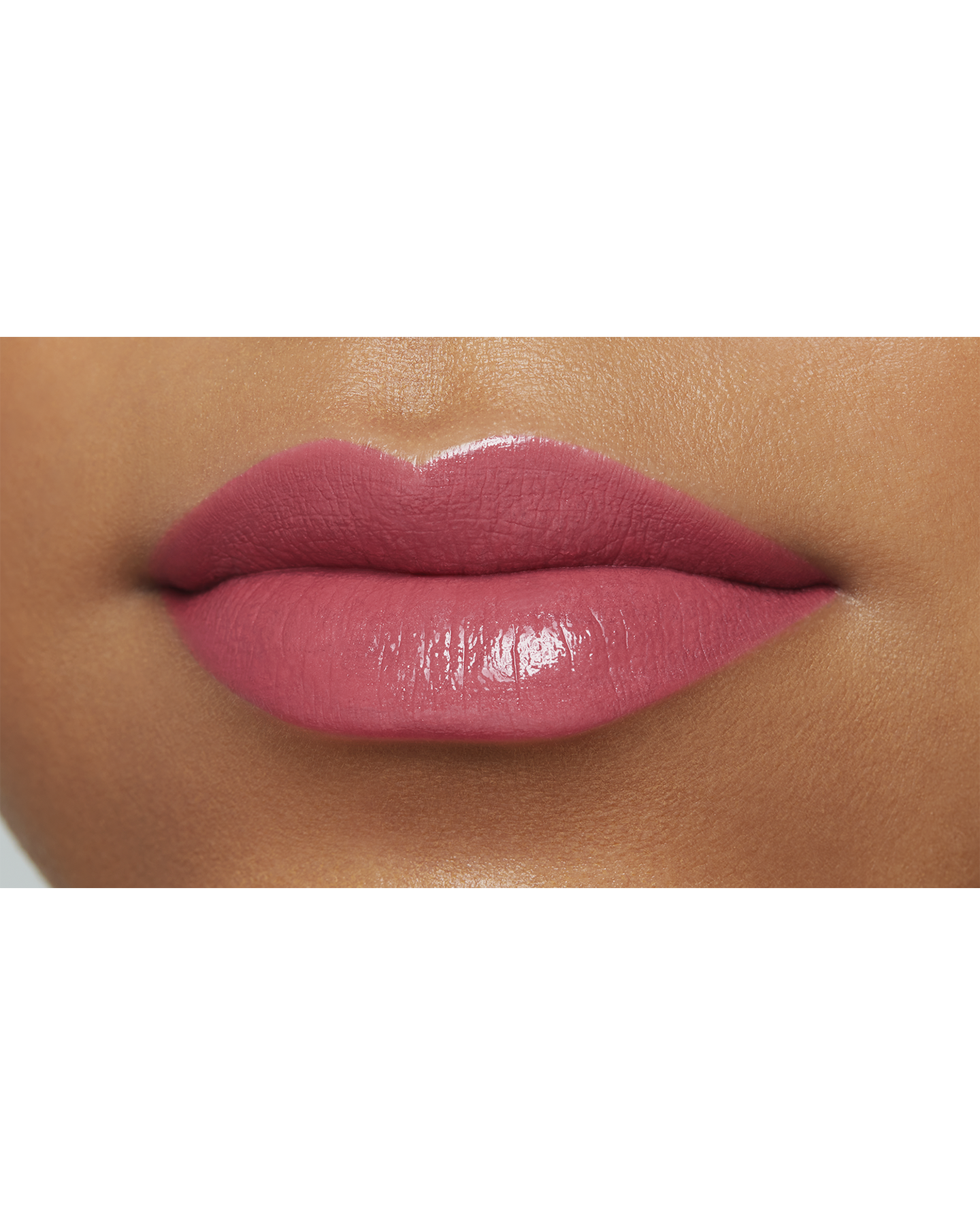 Photo of the lips of a model with a deep skin tone wearing "LIPSTICK" in the shade Erysimum.