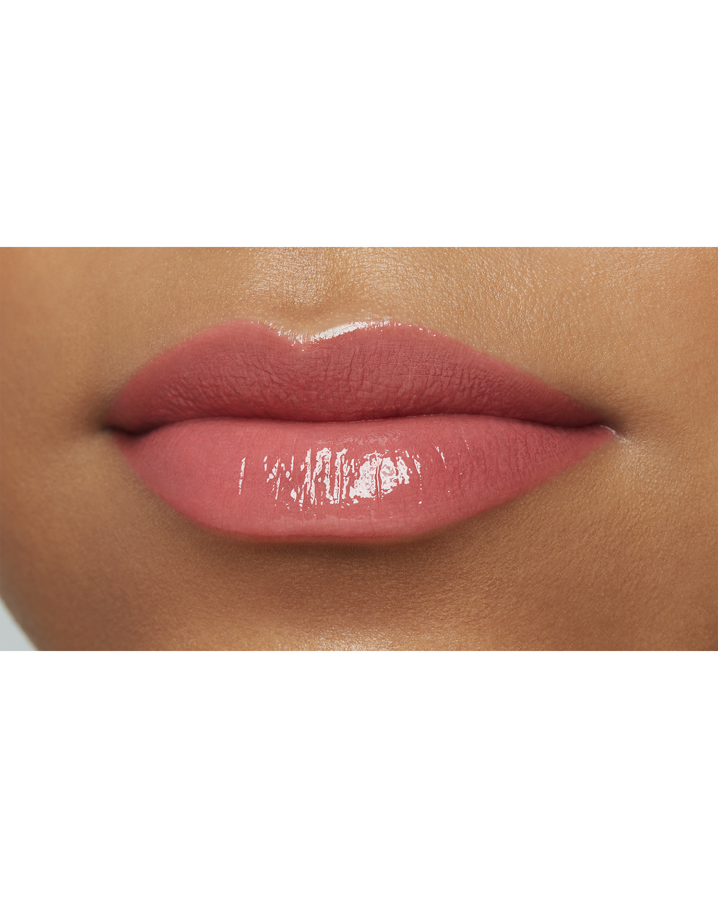 Photo of a deep skin tone model  wearing  "LIPSTICK SHINE" in Knockout Nectar on the lips.