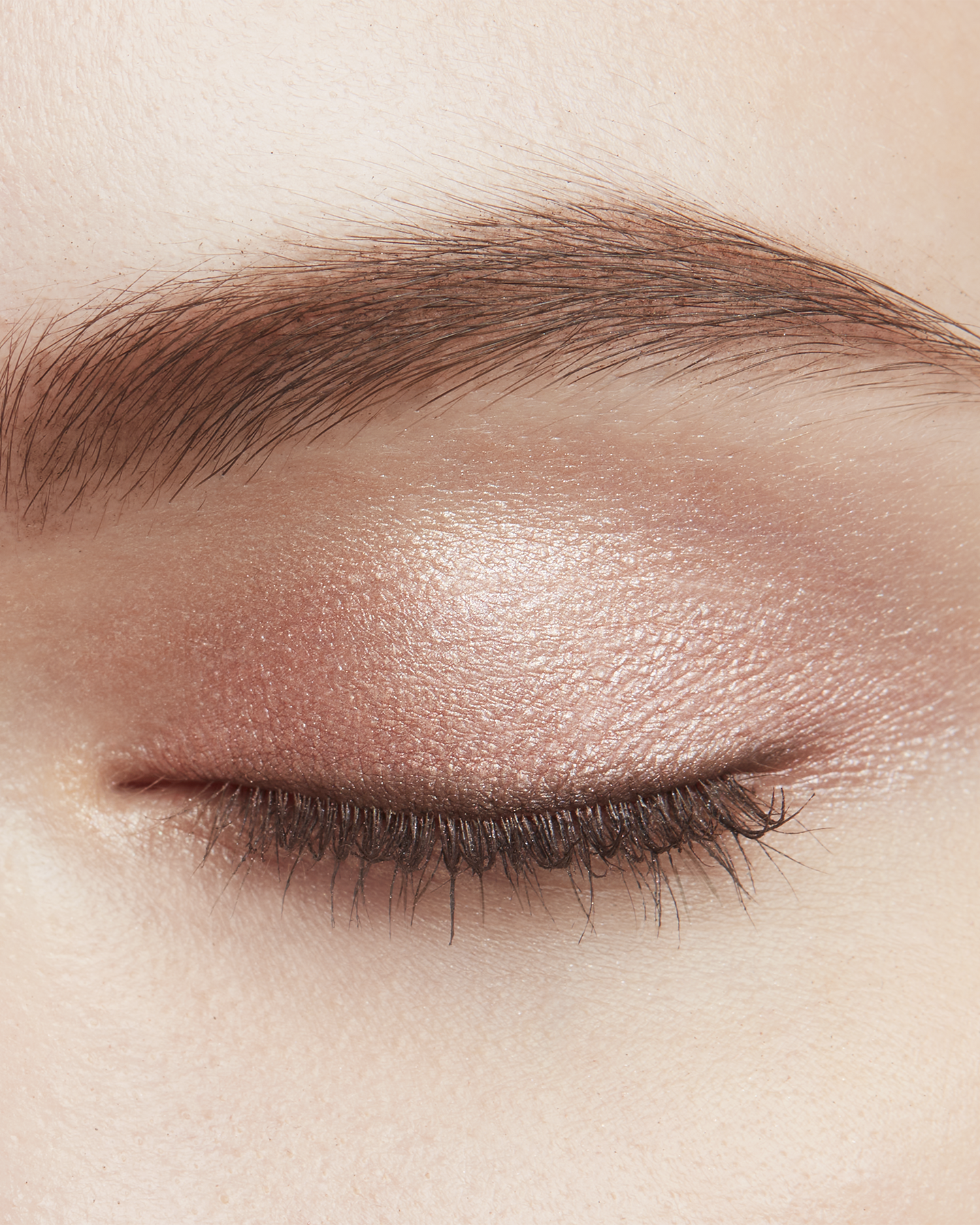 Photo of a light skin tone model wearing EYE COLOR QUAD in 2-Beach Pebbles on the eyes.