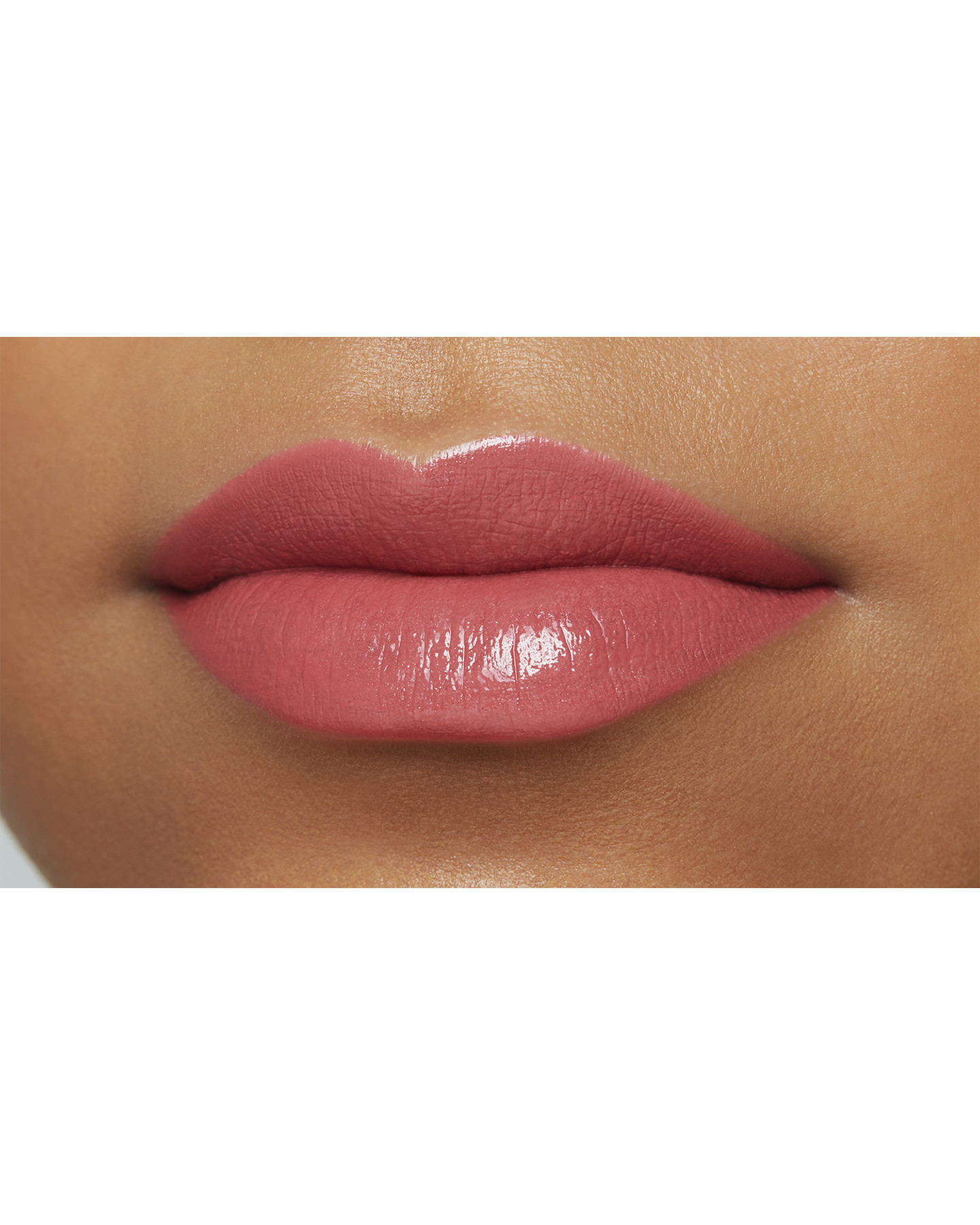 Photo of the lips of a model with a deep skin tone wearing "LIPSTICK" in the shade Snapdragon.