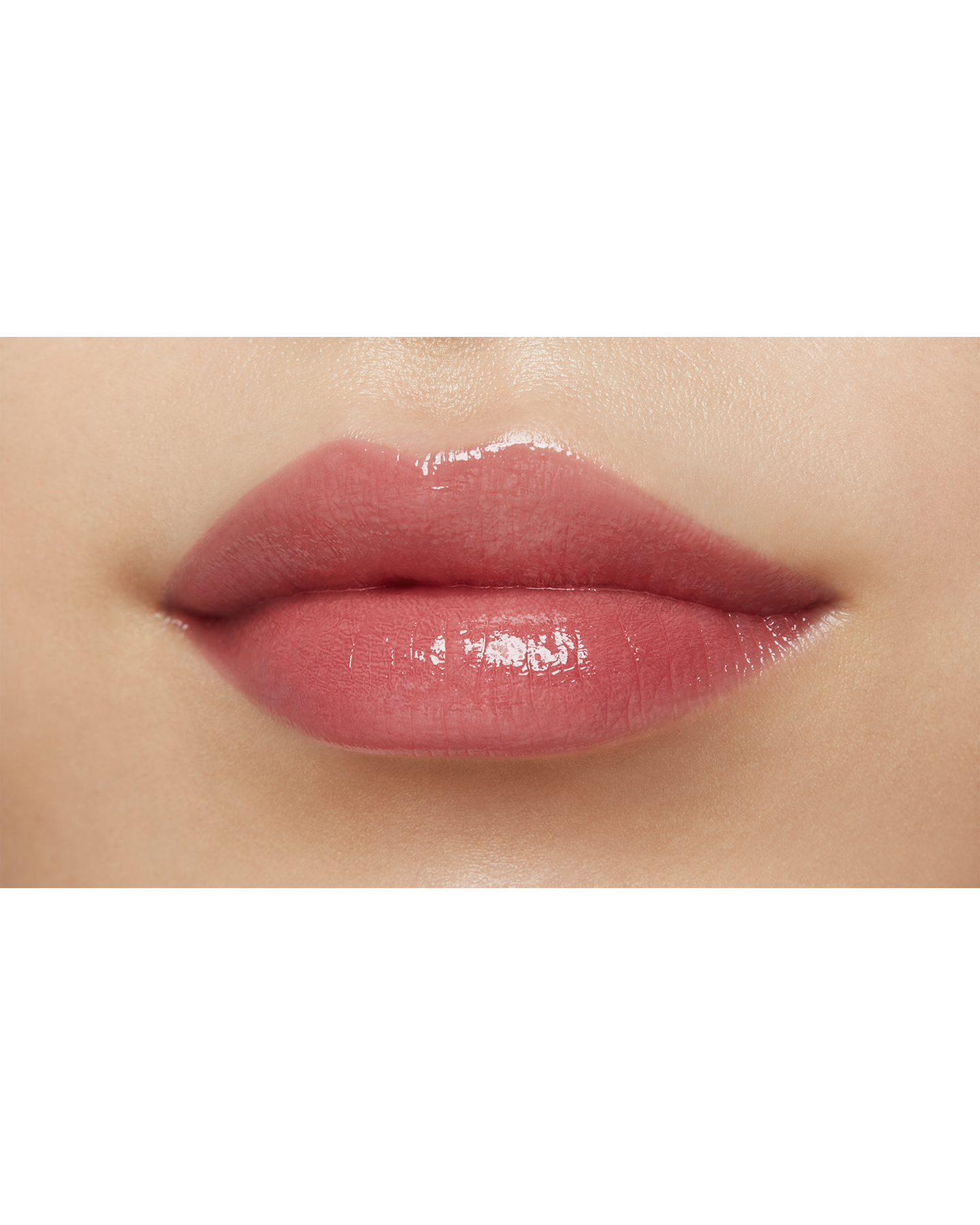 Photo of a medium skin tone model  wearing "LIPSTICK SHINE" in Knockout Nectar on the lips.