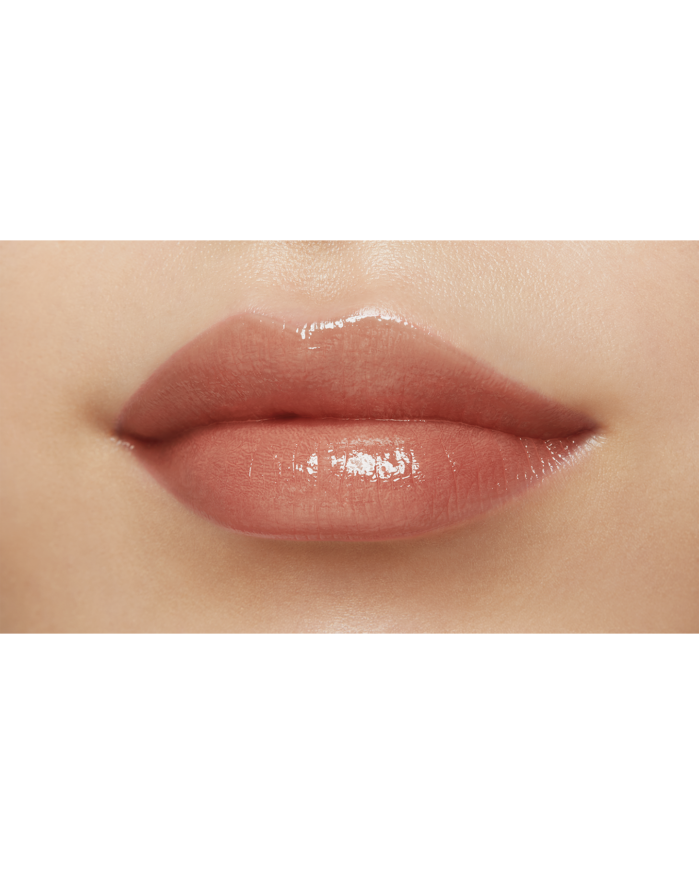 Photo of a medium skin tone model  wearing "LIPSTICK SHINE" in Transcendent on the lips.