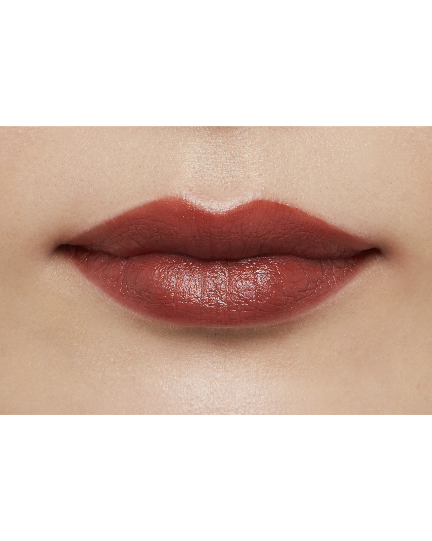Photo of a medium skin tone model  wearing "LIPSTICK MATTE" in High Achieve on the lips.