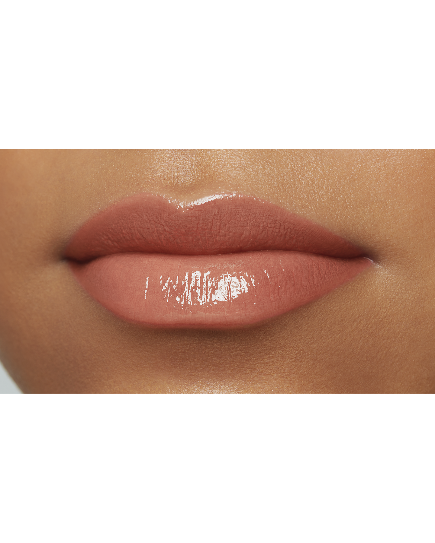 Photo of a deep skin tone model  wearing  "LIPSTICK SHINE" in Transcendent on the lips.